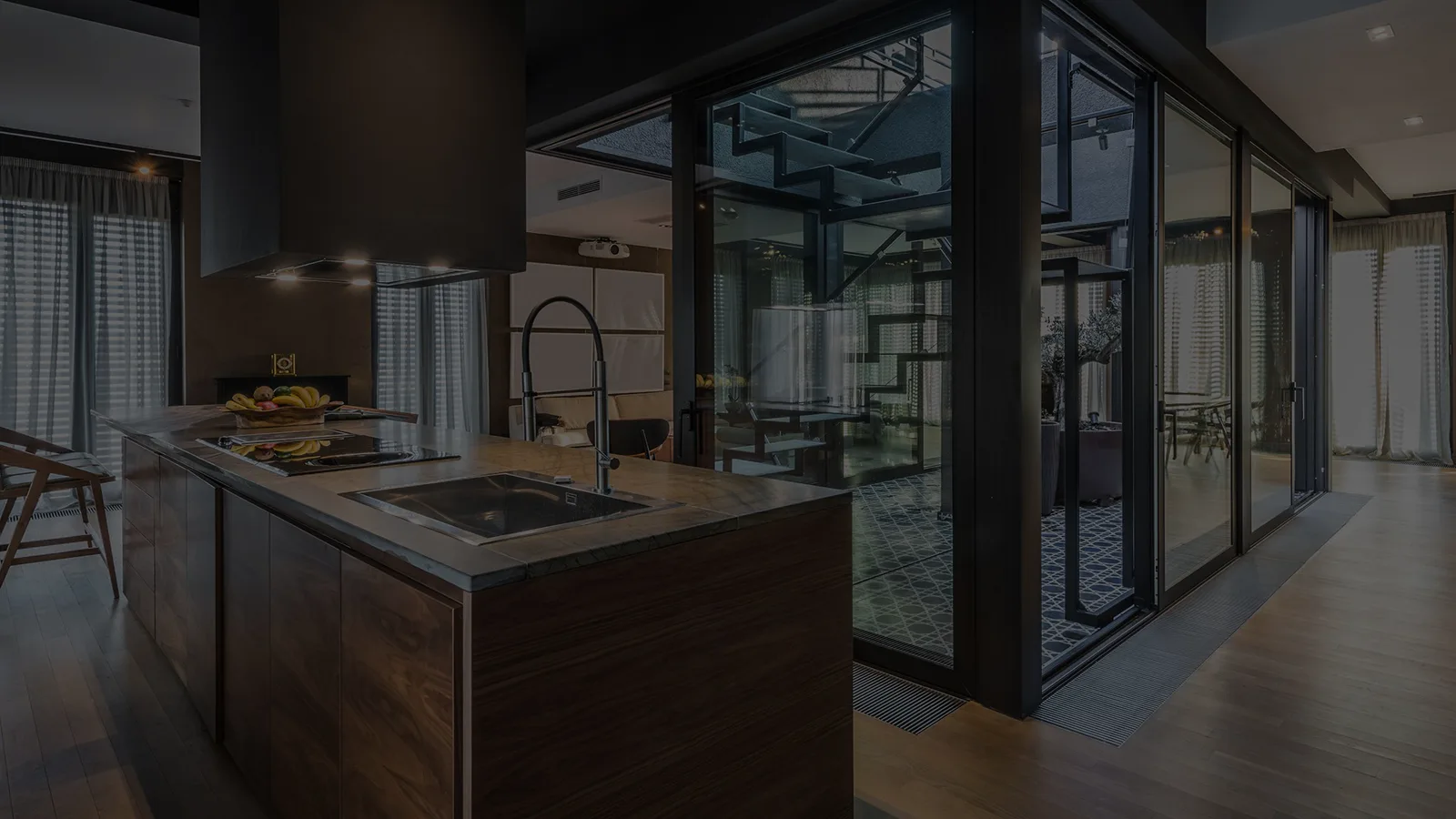 Modern kitchen with dark wood cabinetry and glass doors
