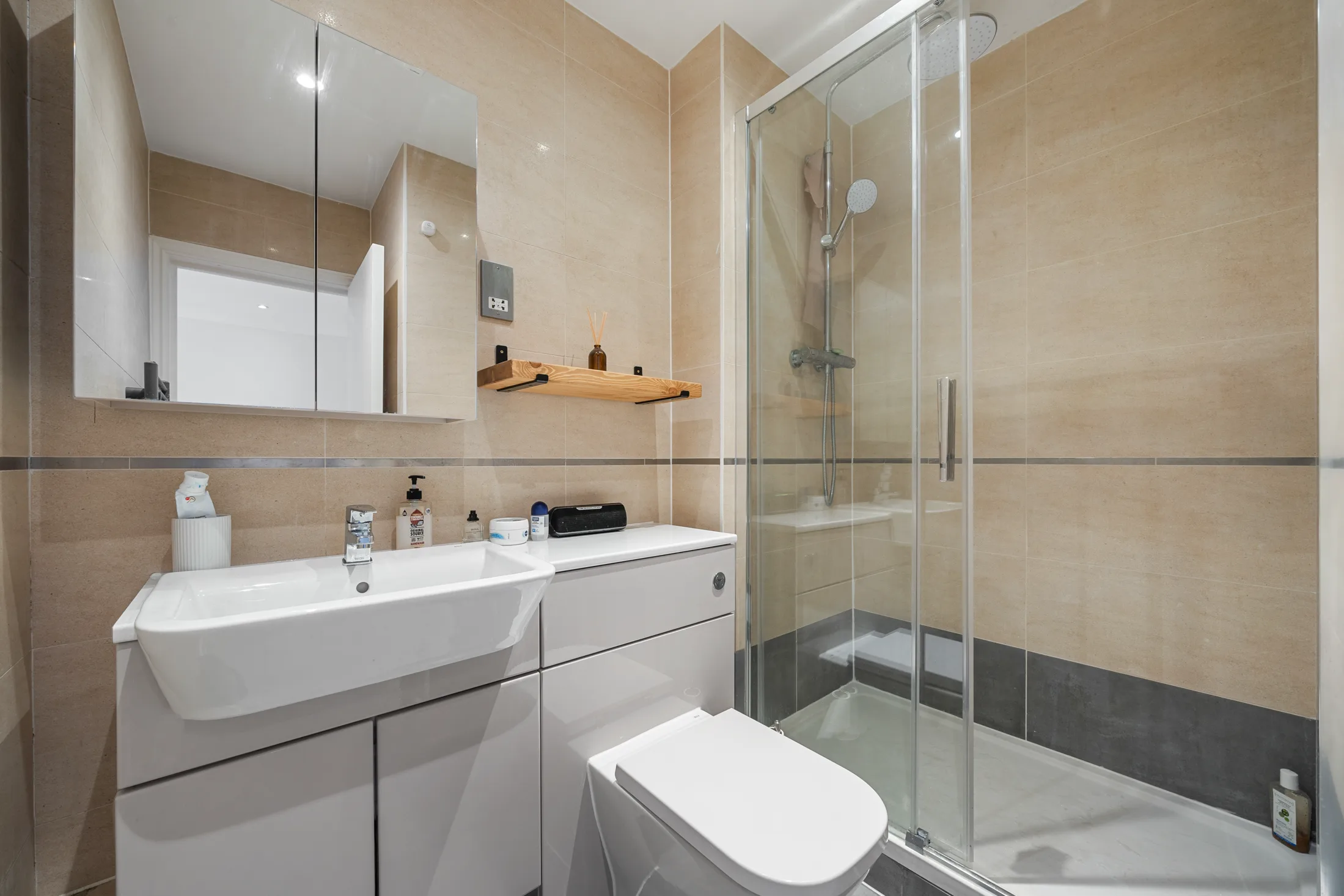 Shower room with a glass enclosure and wall-mounted basin