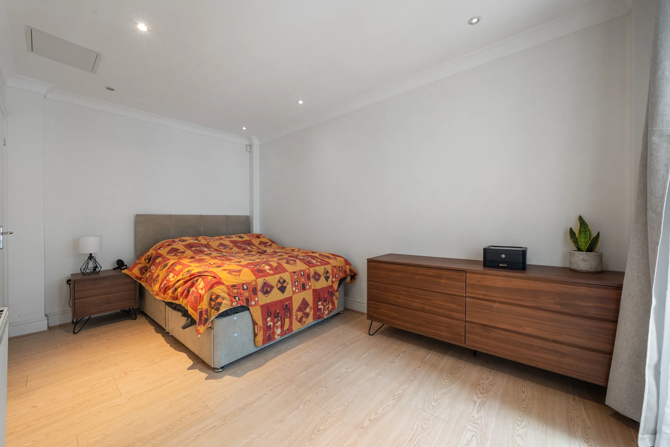 Bedroom with a double bed, chest of drawers and window