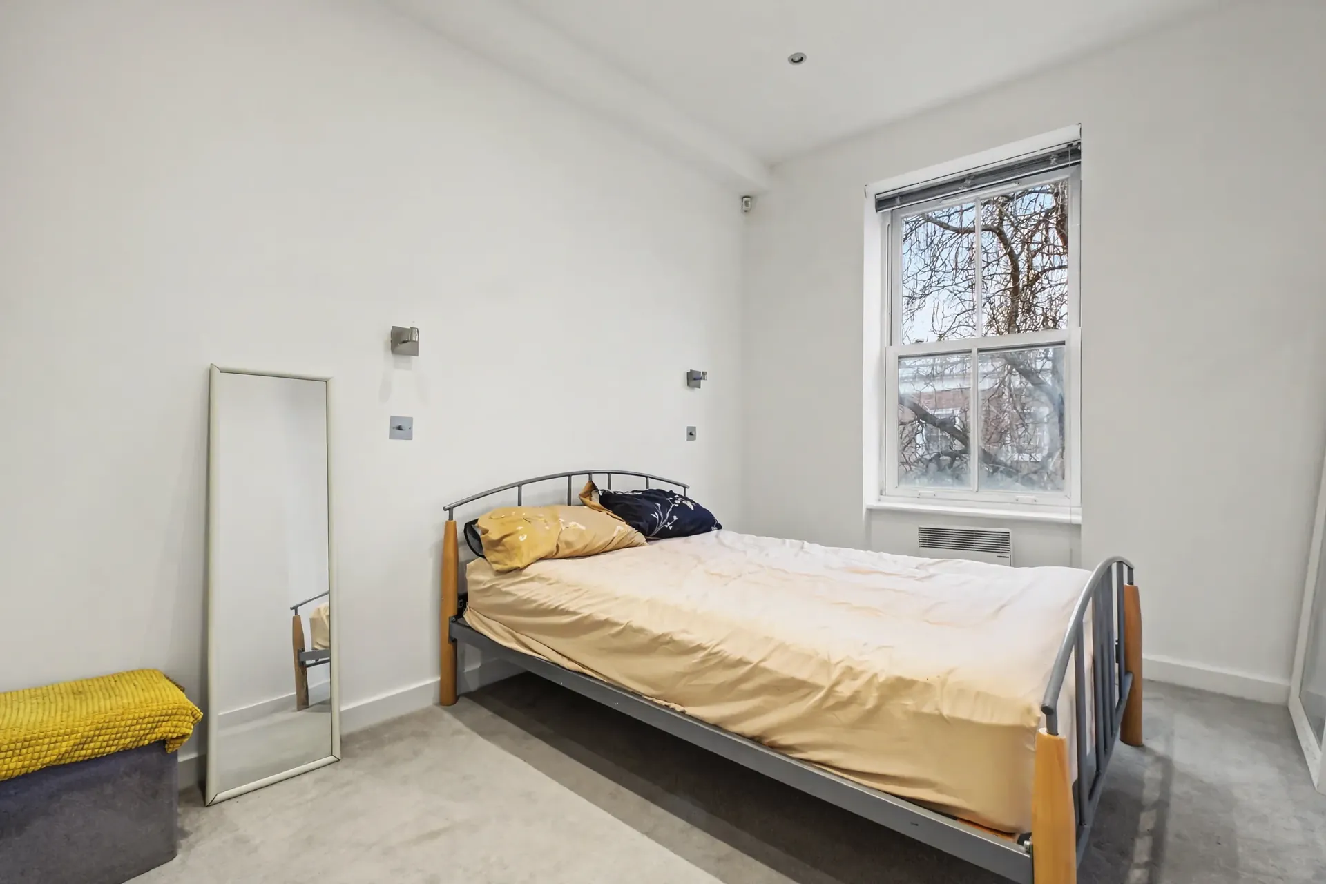 Bedroom with a sash window overlooking the trees