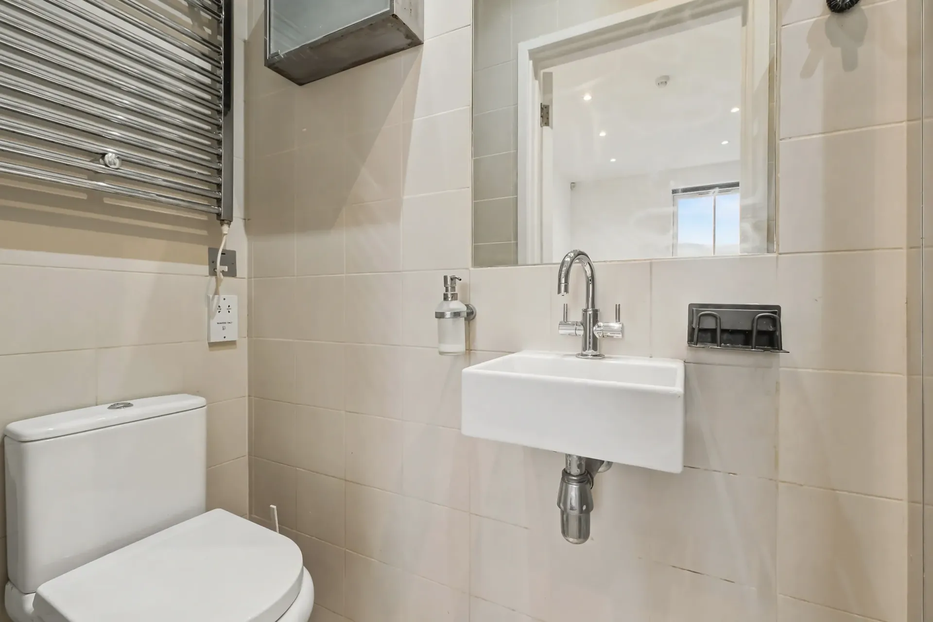 Shower room with a wall-hung basin and tiled walls