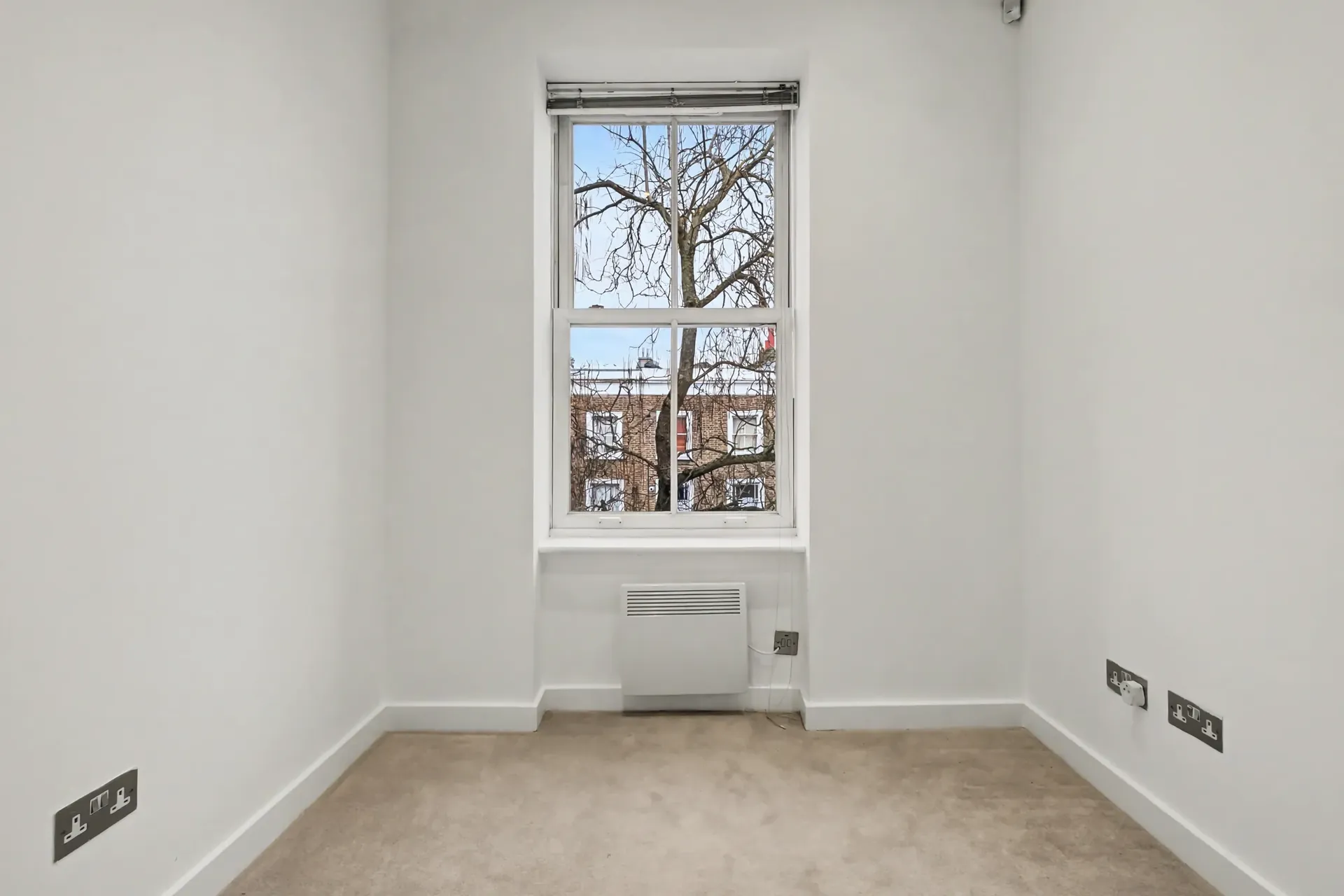 Office with a sash window and carpet