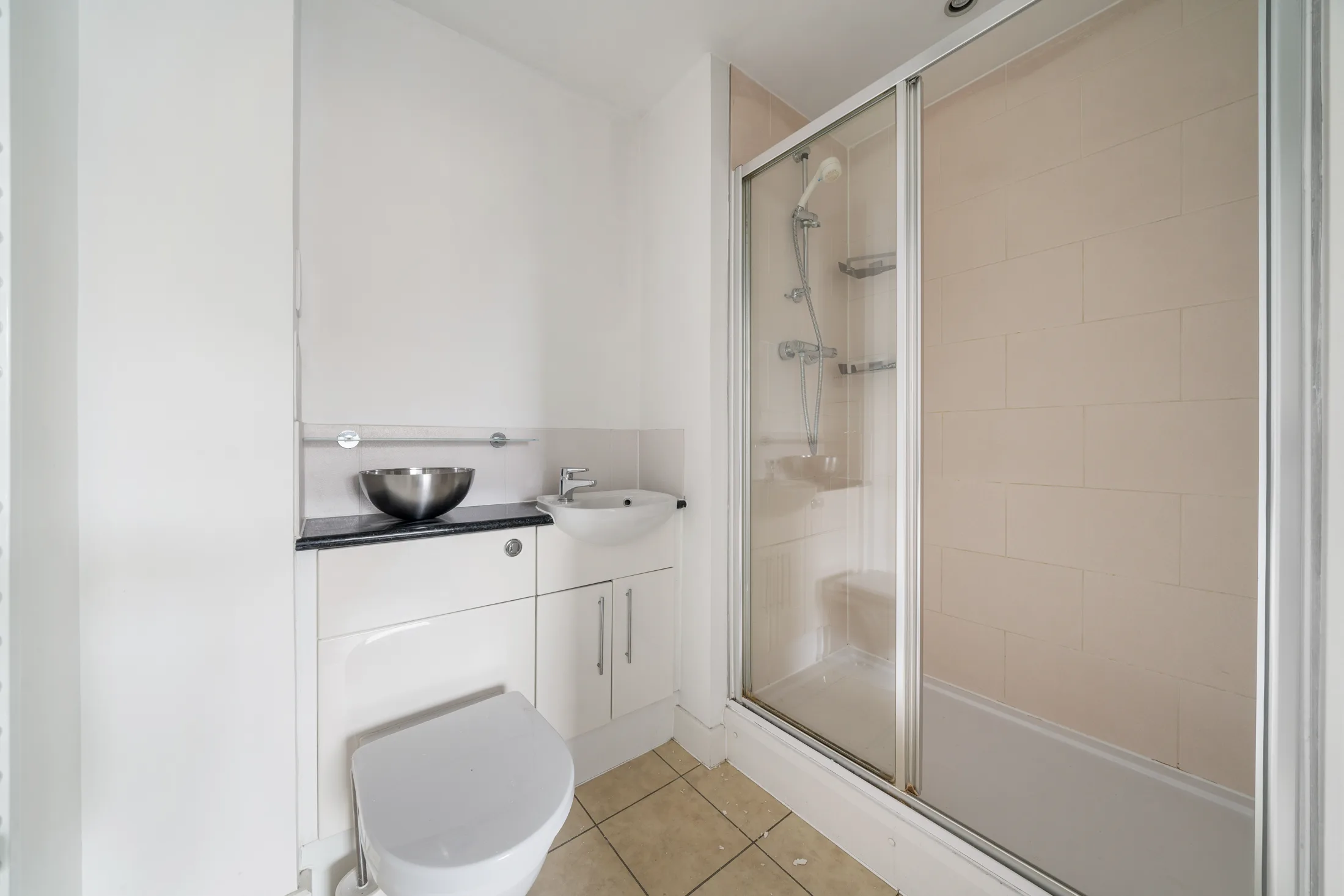 Shower room with a glass enclosure and tiled floor