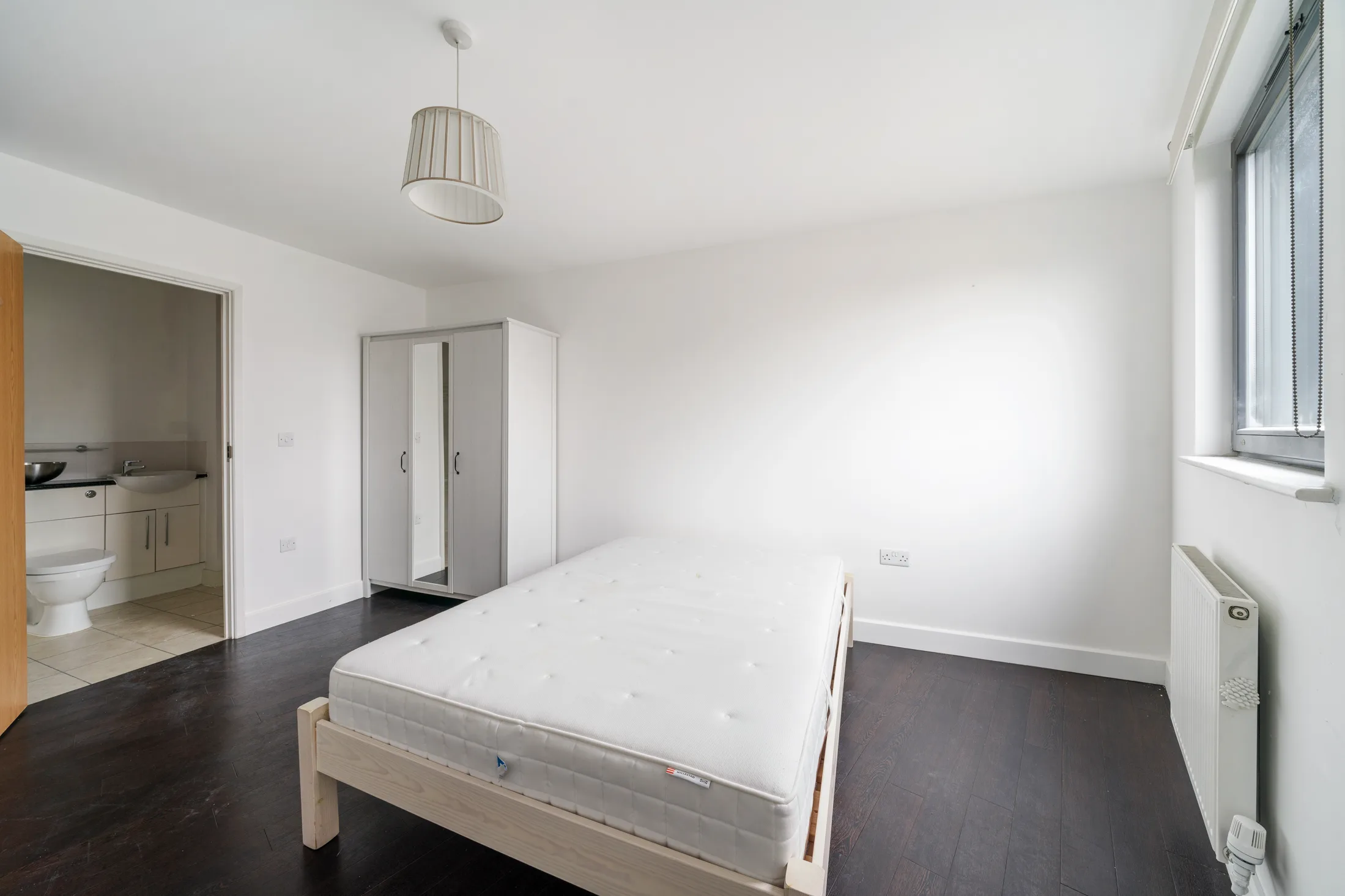 Bedroom with a double bed, wardrobe and window