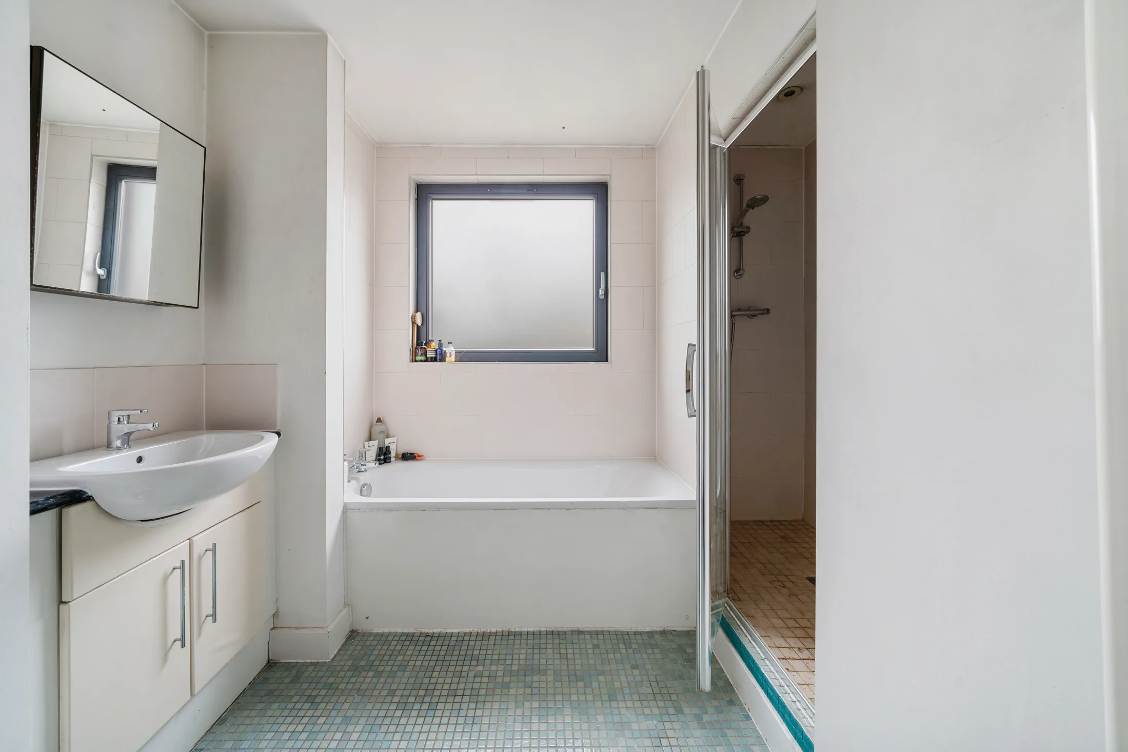Bathroom with a bath, basin and window