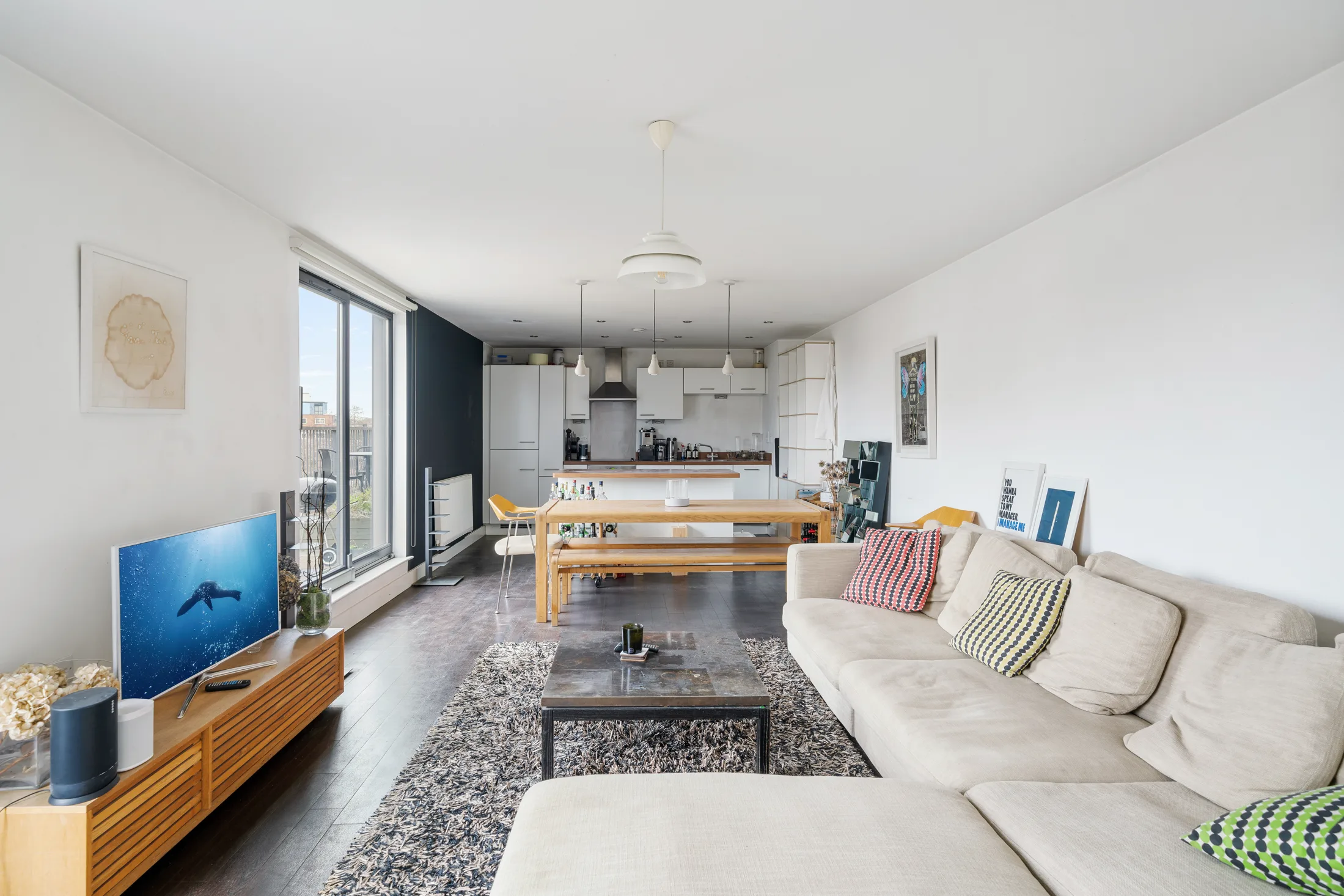Reception room with kitchen, dining area and doors to the terrace