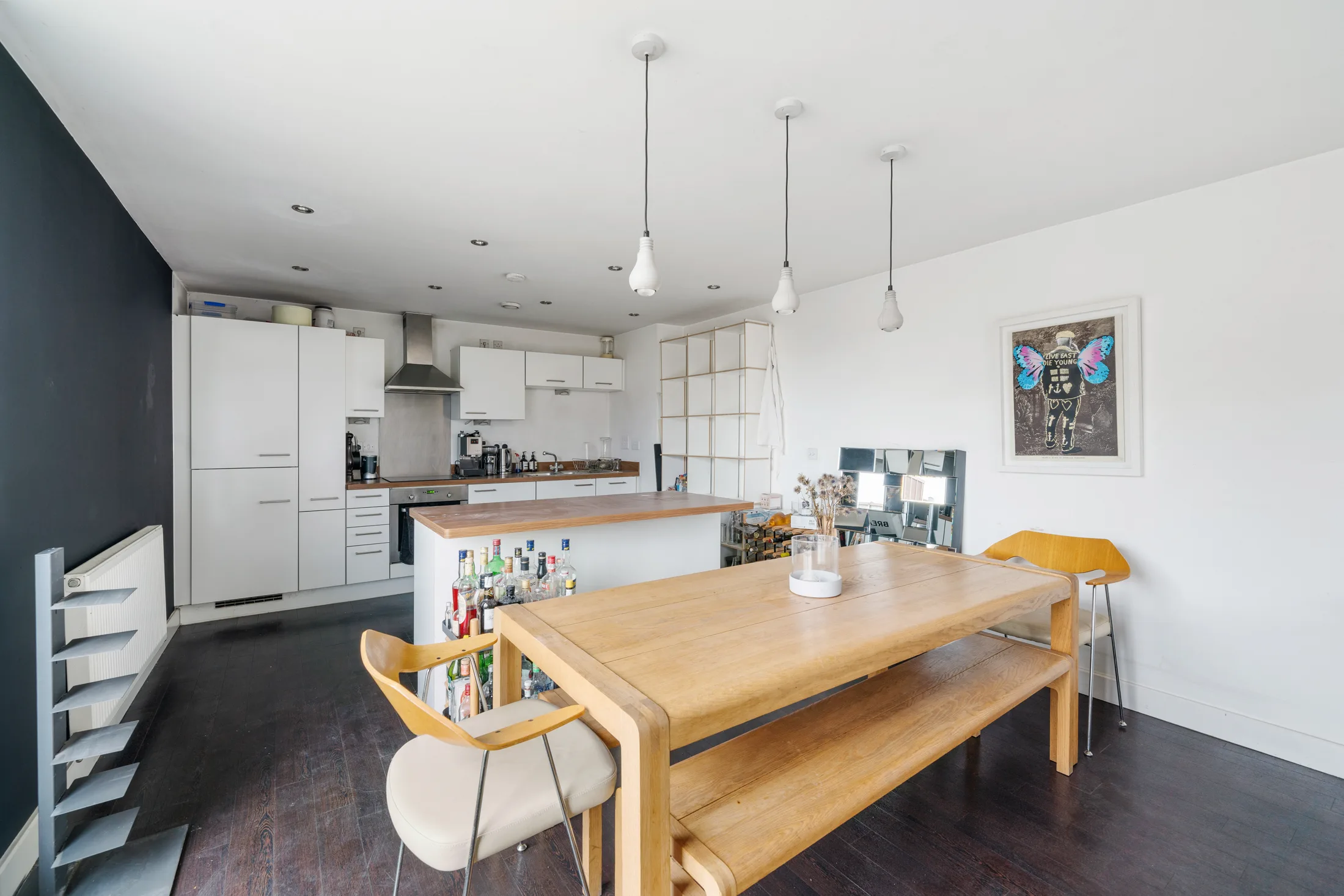 Open-plan kitchen and dining area with pendant lights