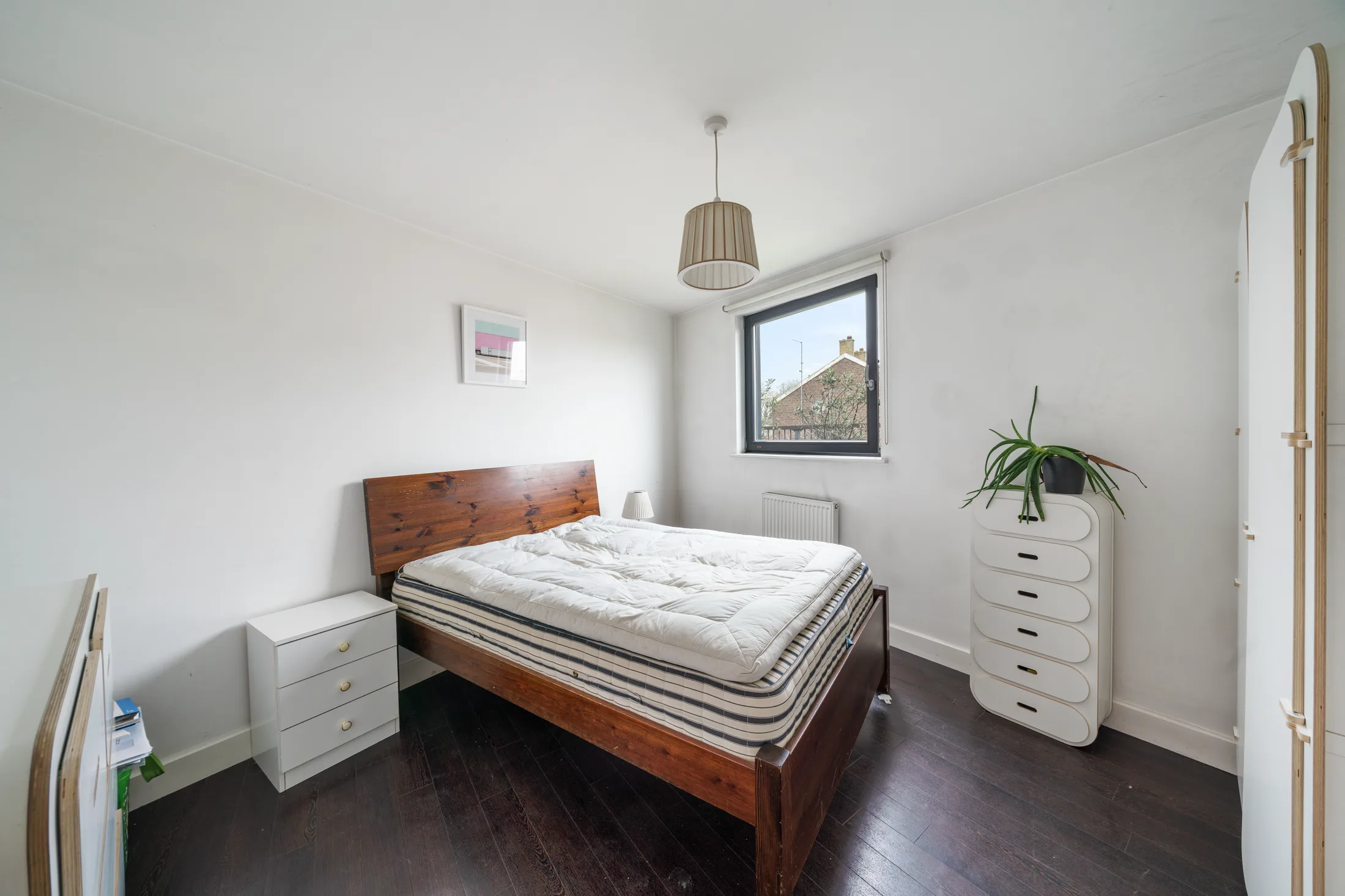 Bedroom with a double bed, chest of drawers and window