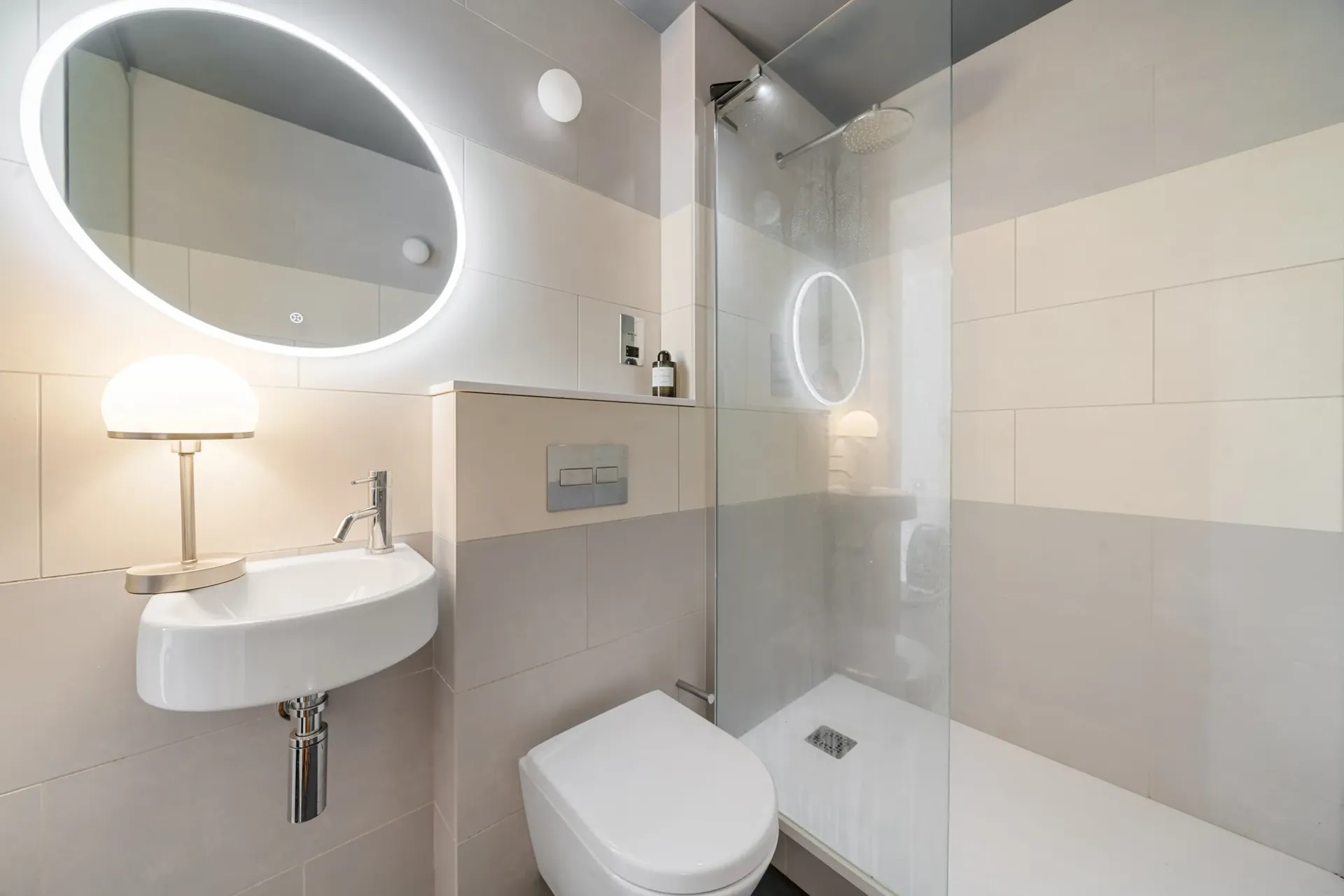 Modern shower room with an illuminated mirror and walk-in shower