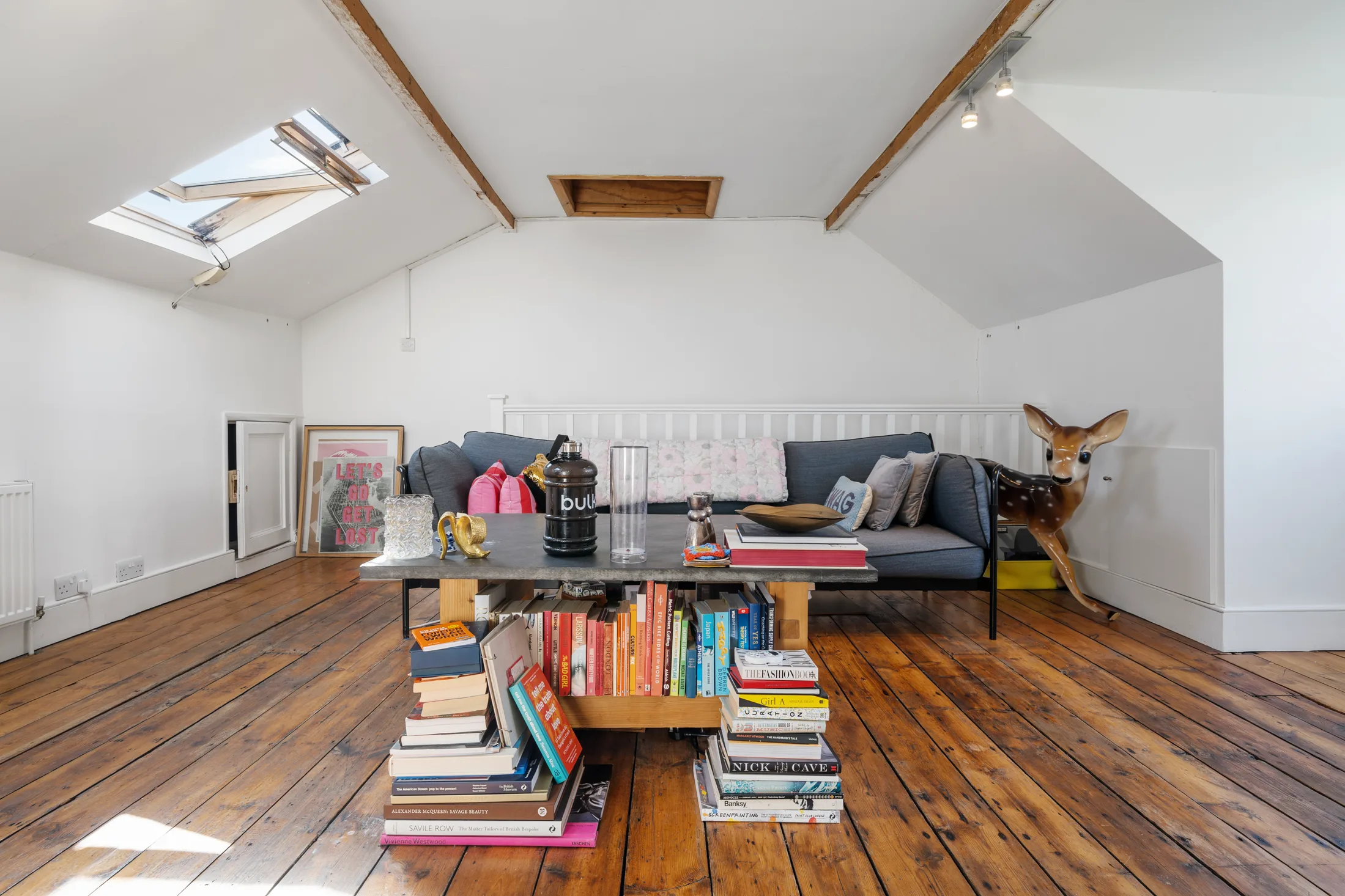 Top-floor reception room with timber flooring, skylights and seating