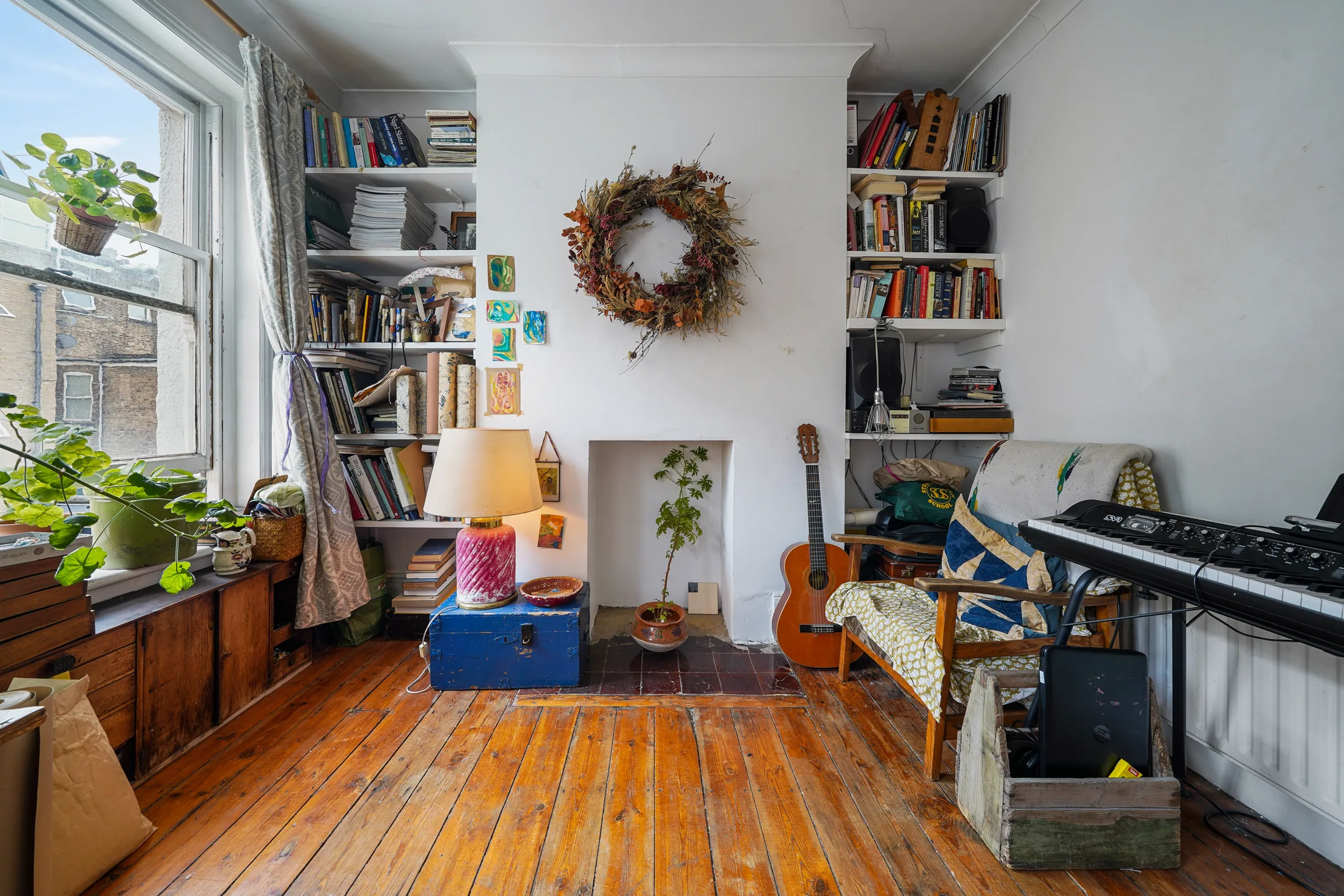 Reception room with bookshelves, timber flooring and natural light