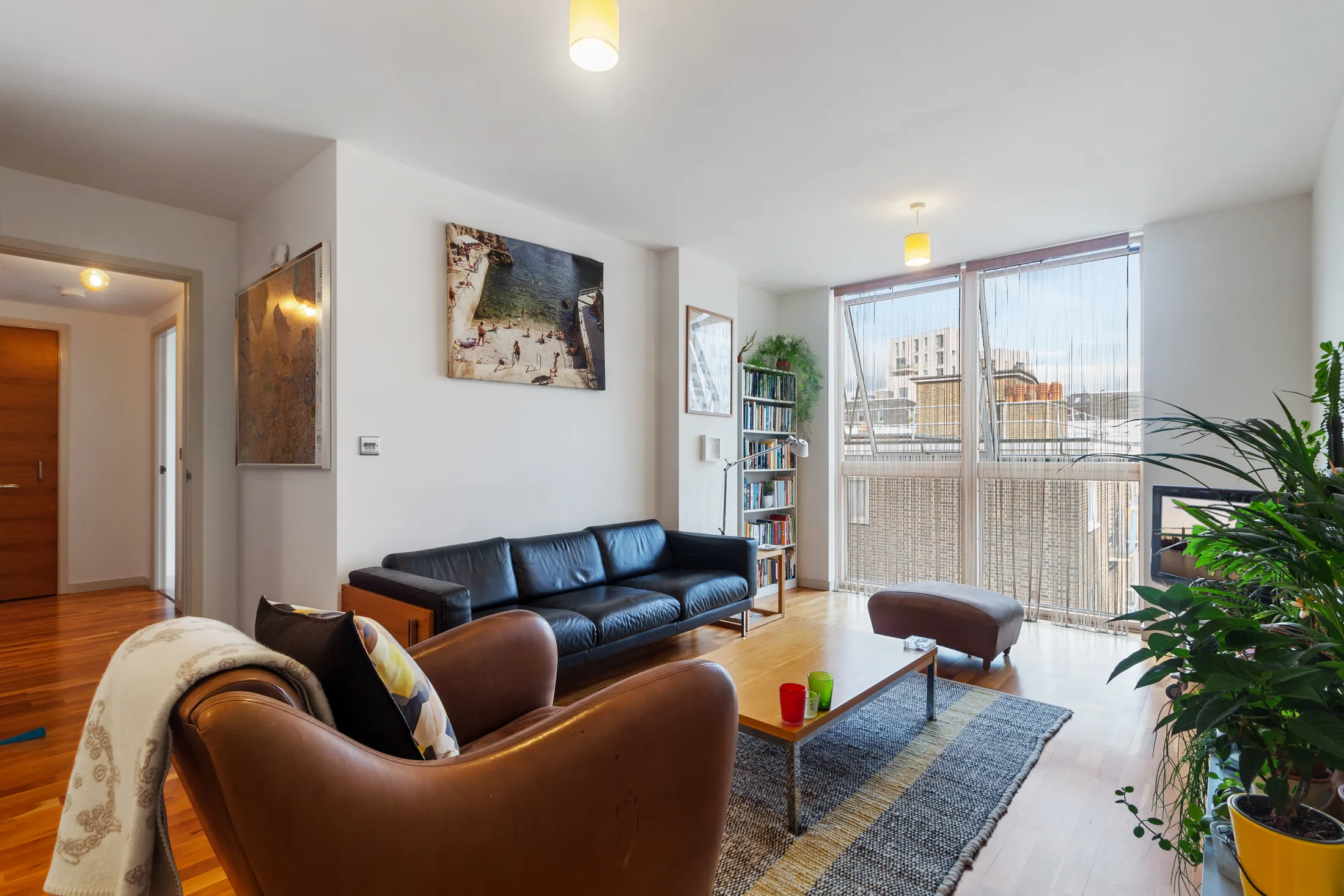 Reception room with sofas, a coffee table and timber flooring