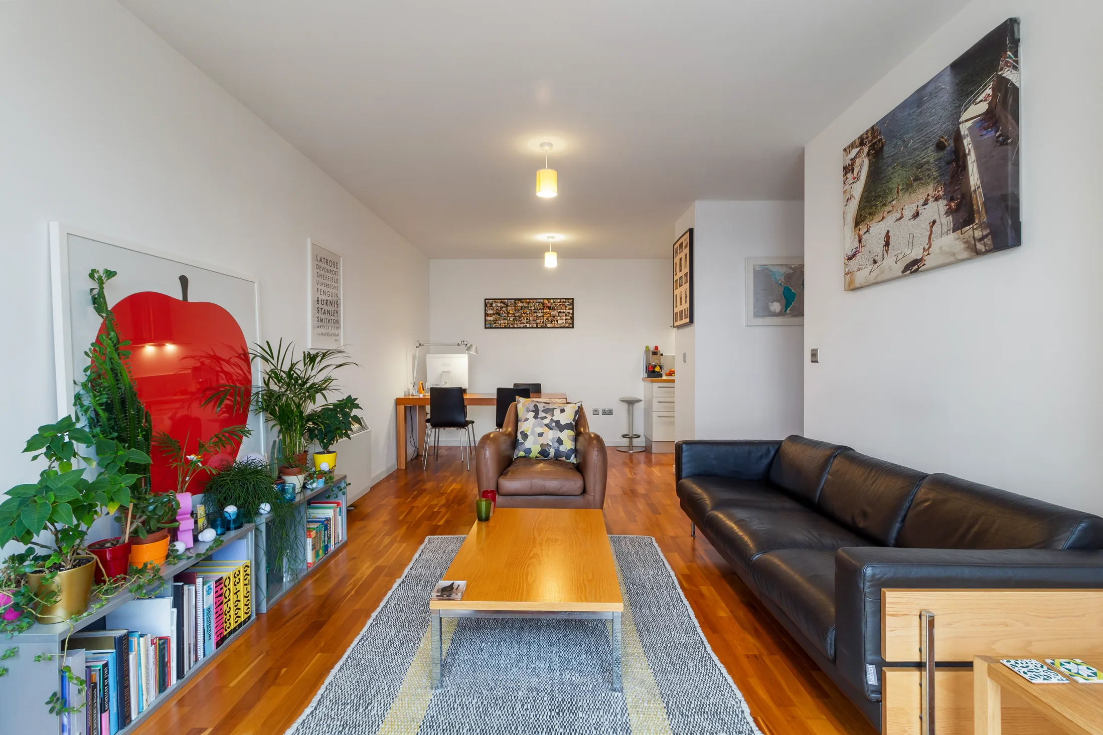 Reception room with sofas, dining table, artwork and plants
