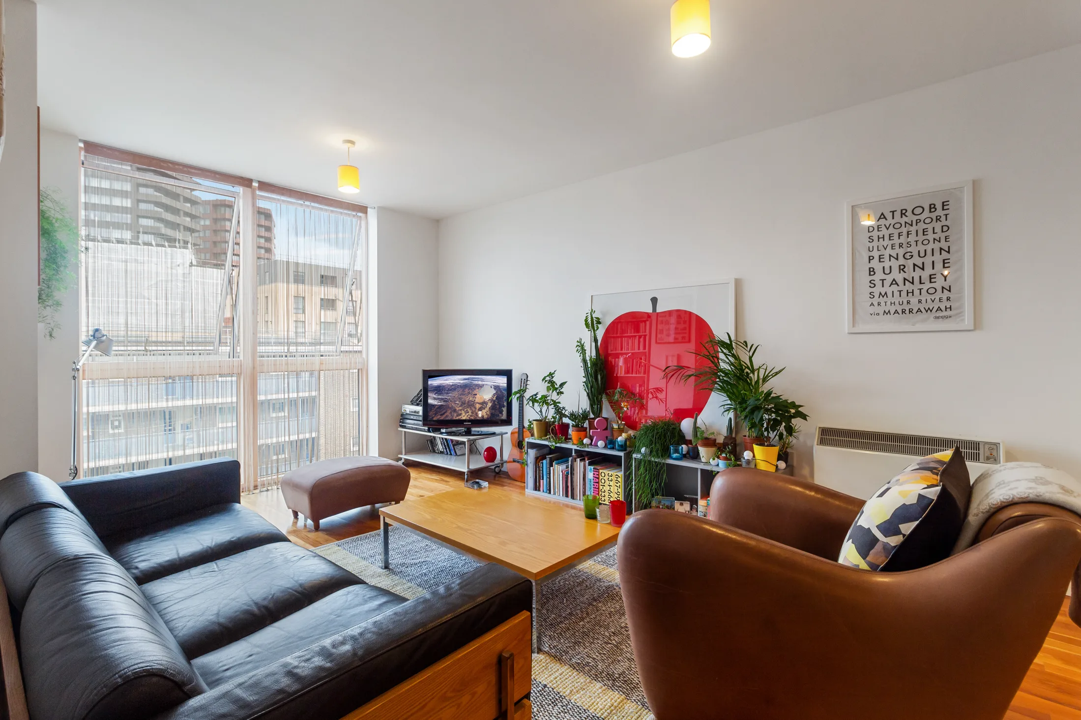 Reception room with seating, timber flooring and a large window