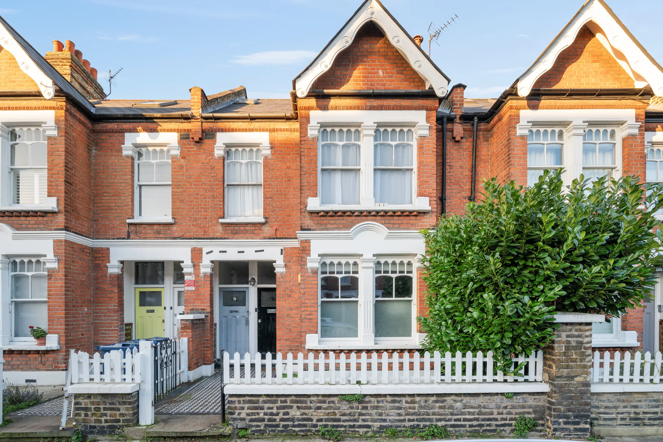 Red-brick terraced house frontage on Jeddo Road with a small front garden