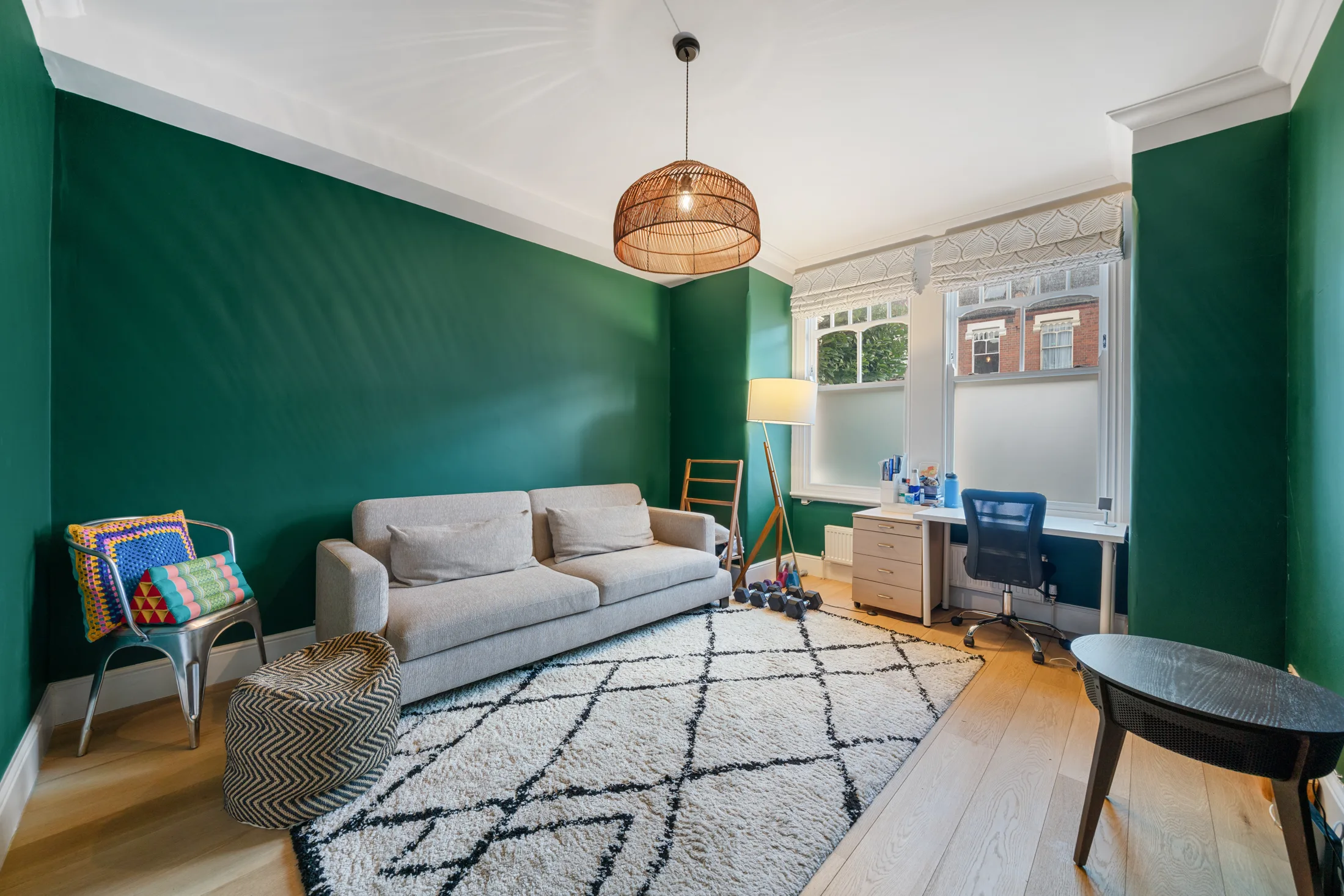 Reception room with green walls, sofa and floor lamp
