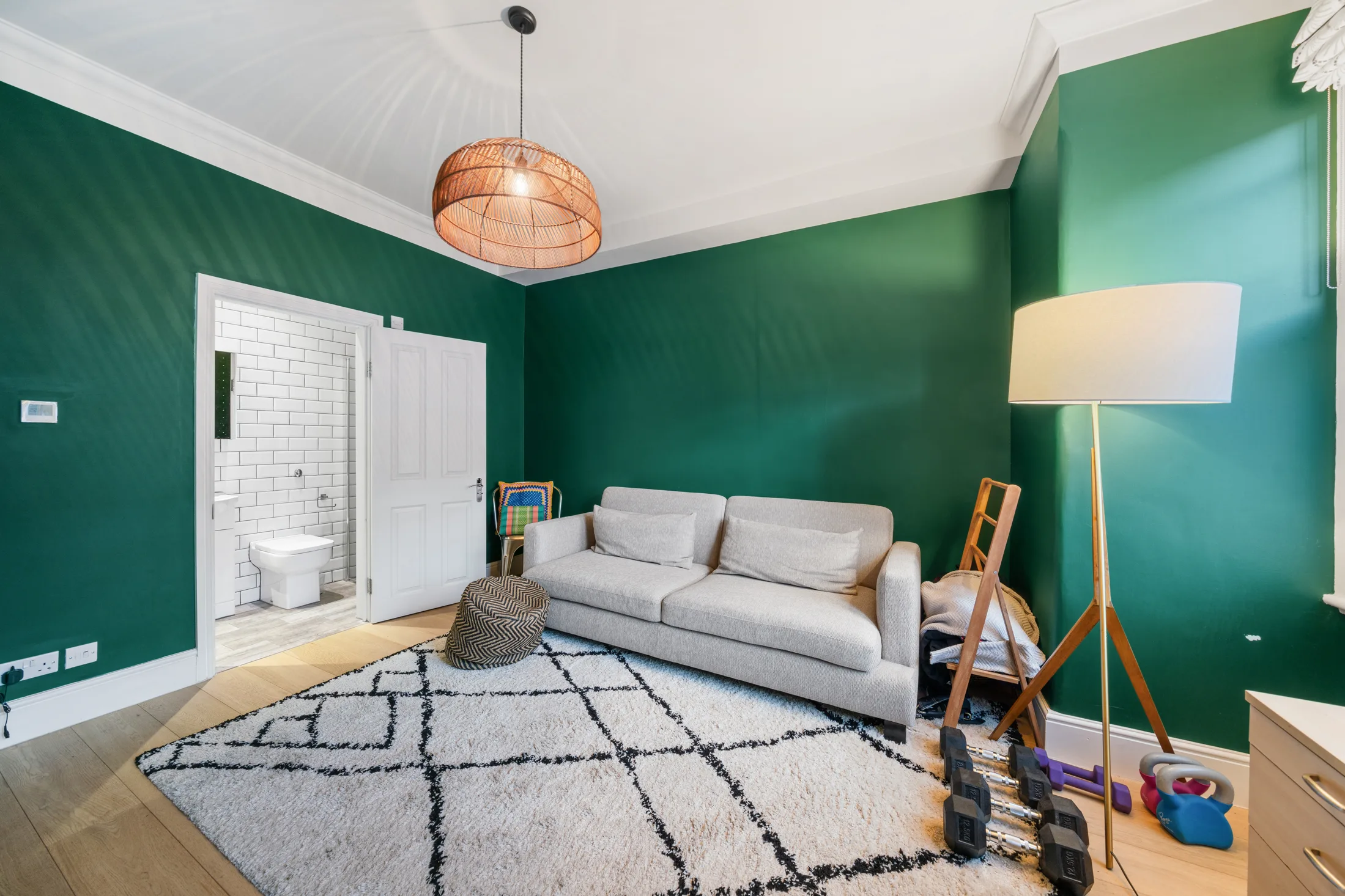 Reception room with green walls, sofa and French doors