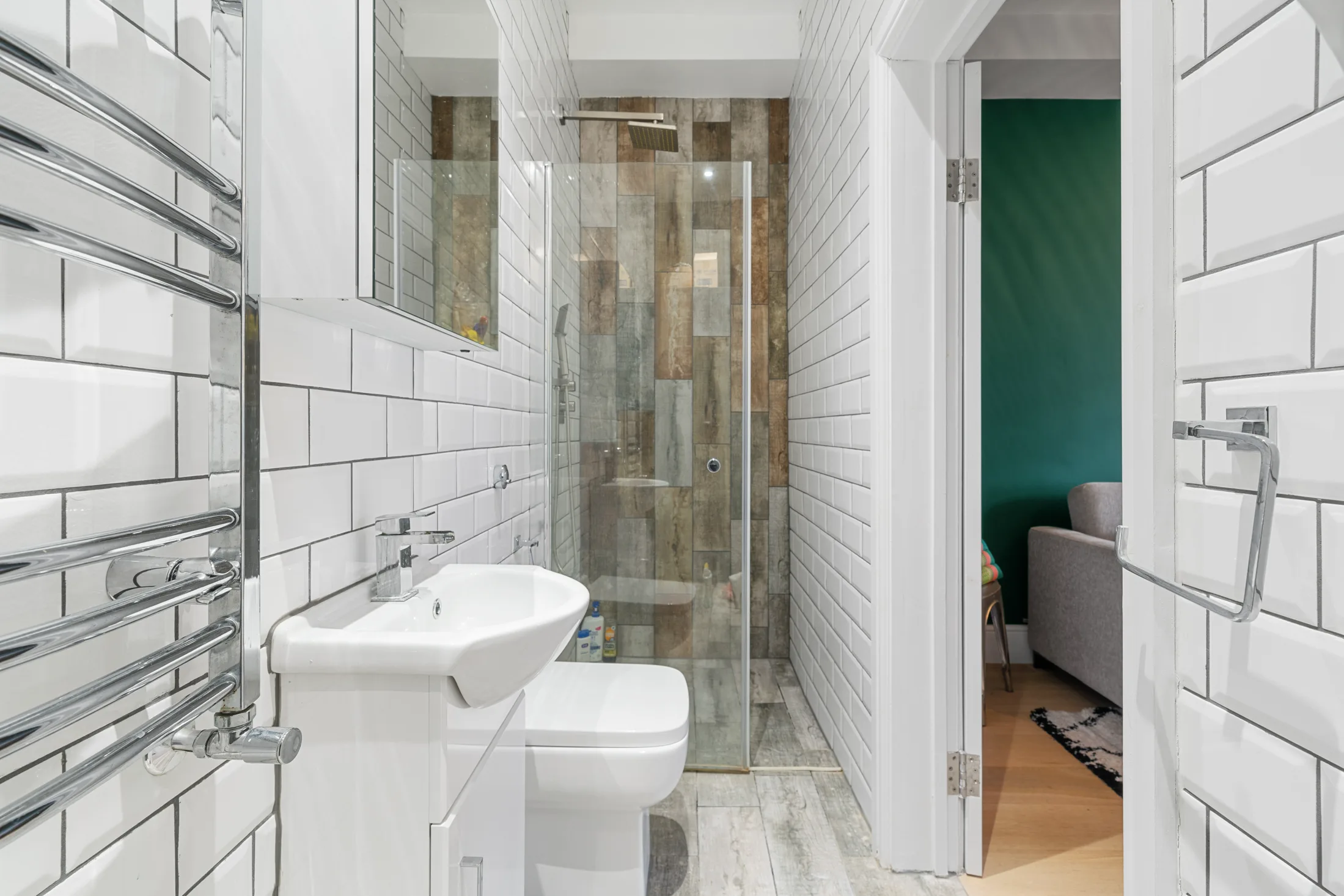 Shower room with white tiled walls and glass shower enclosure