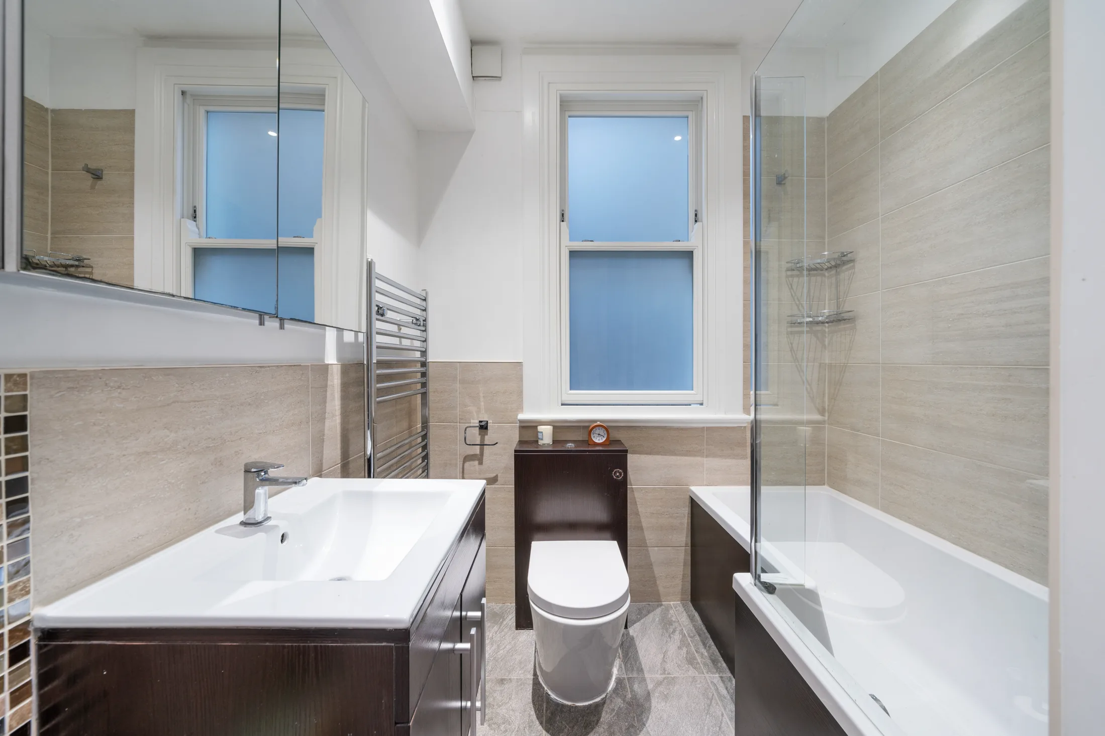 Bathroom with bath, shower and white tiled walls