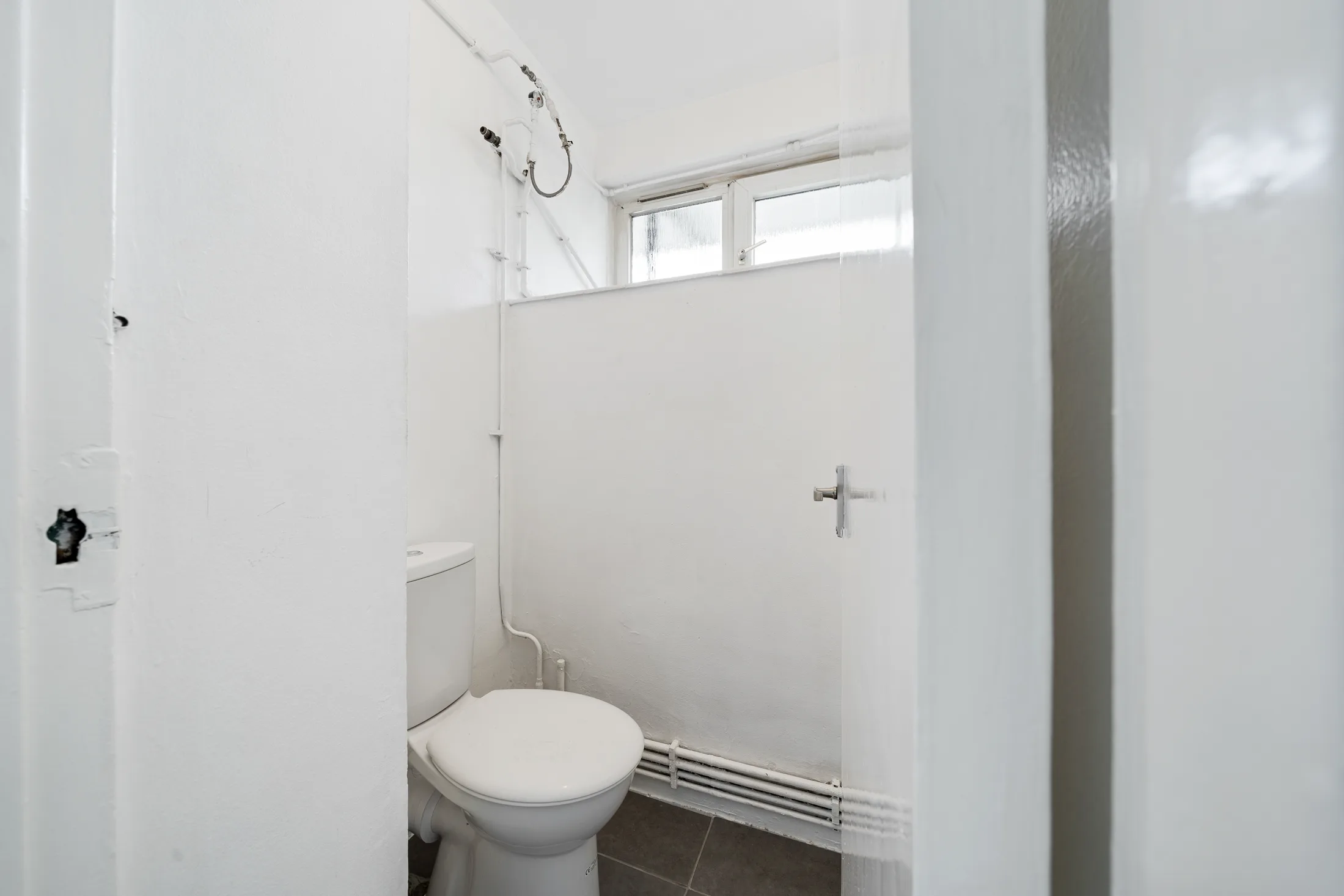 Bathroom with a shower, basin and white sanitaryware