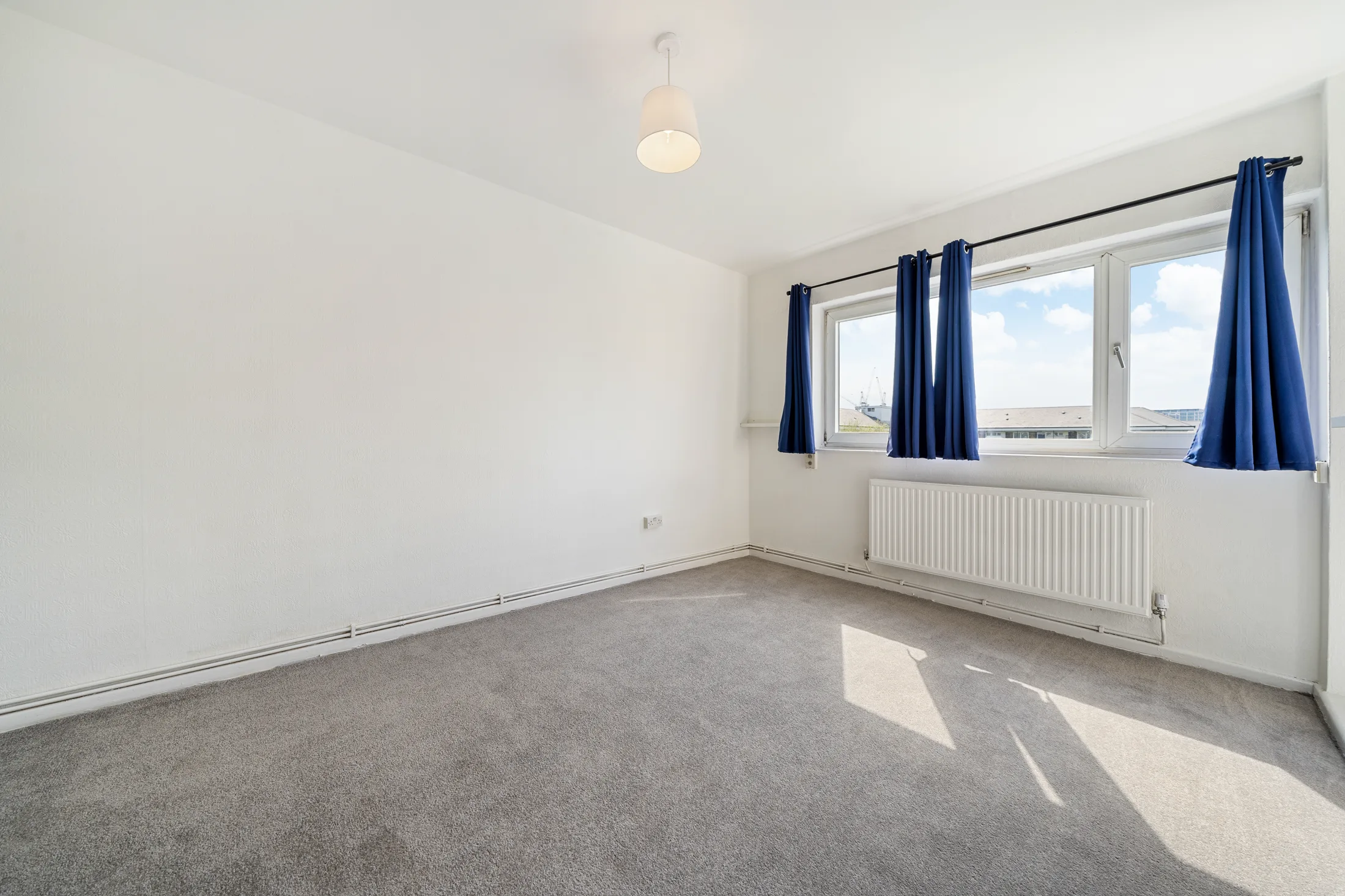 Bedroom with carpet, a window and fitted storage