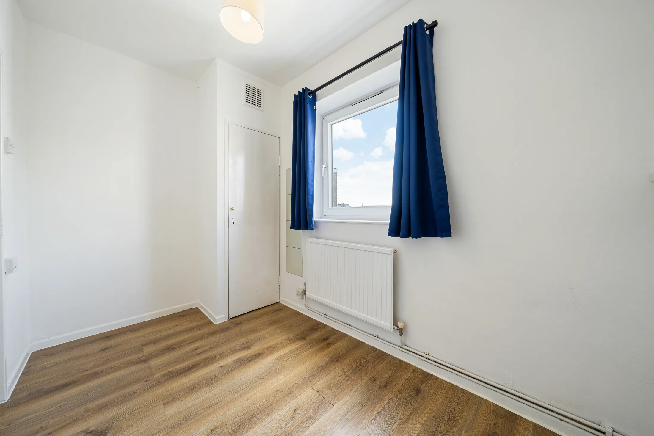 Bedroom with timber flooring and a window