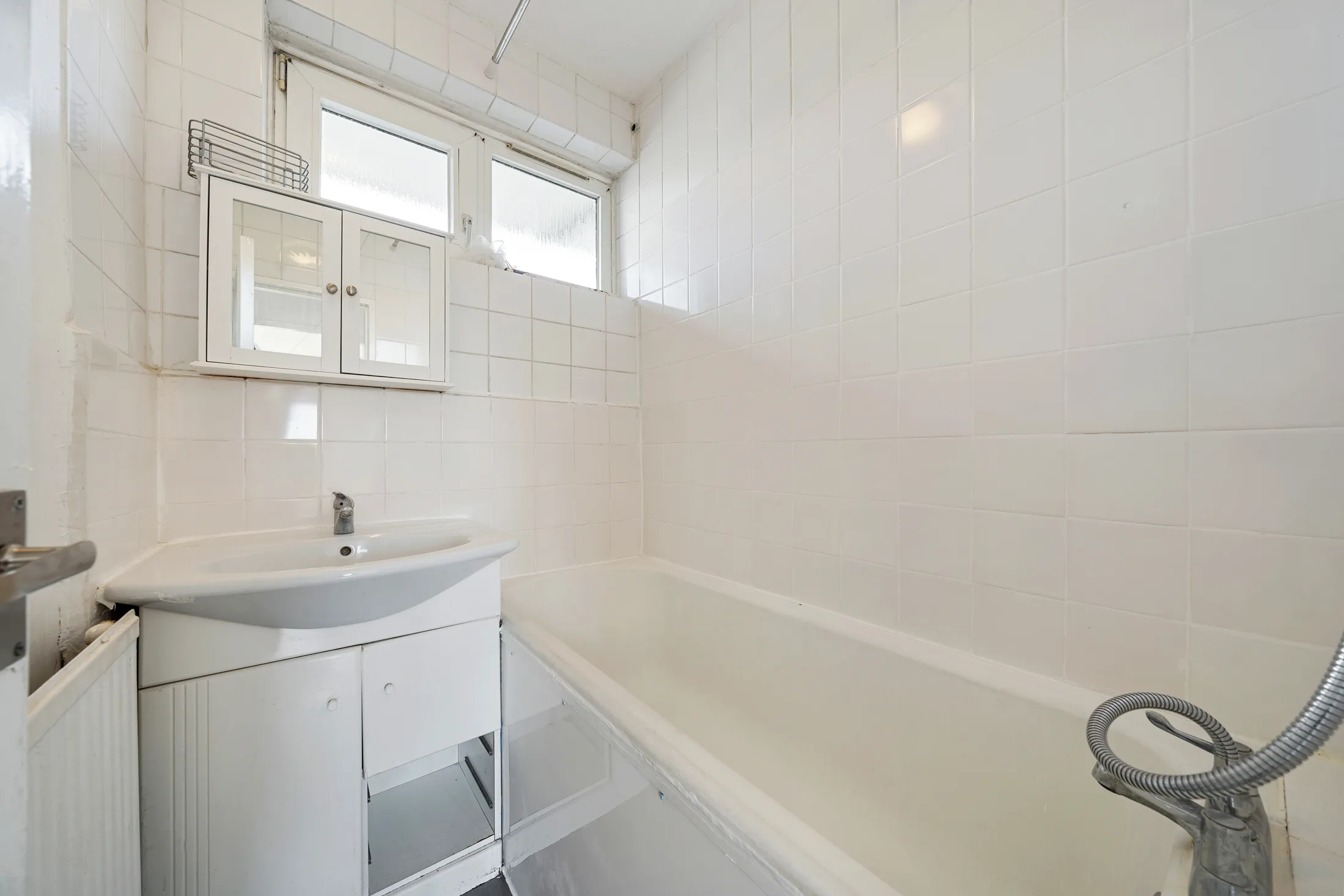 Bathroom with a bath, shower and white sanitaryware