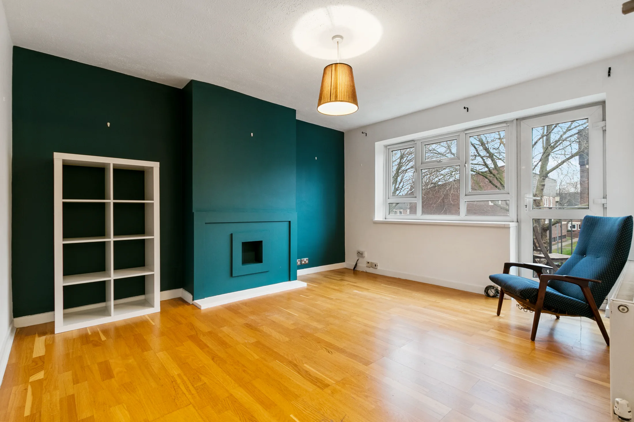 Living room with a teal accent wall and sofa