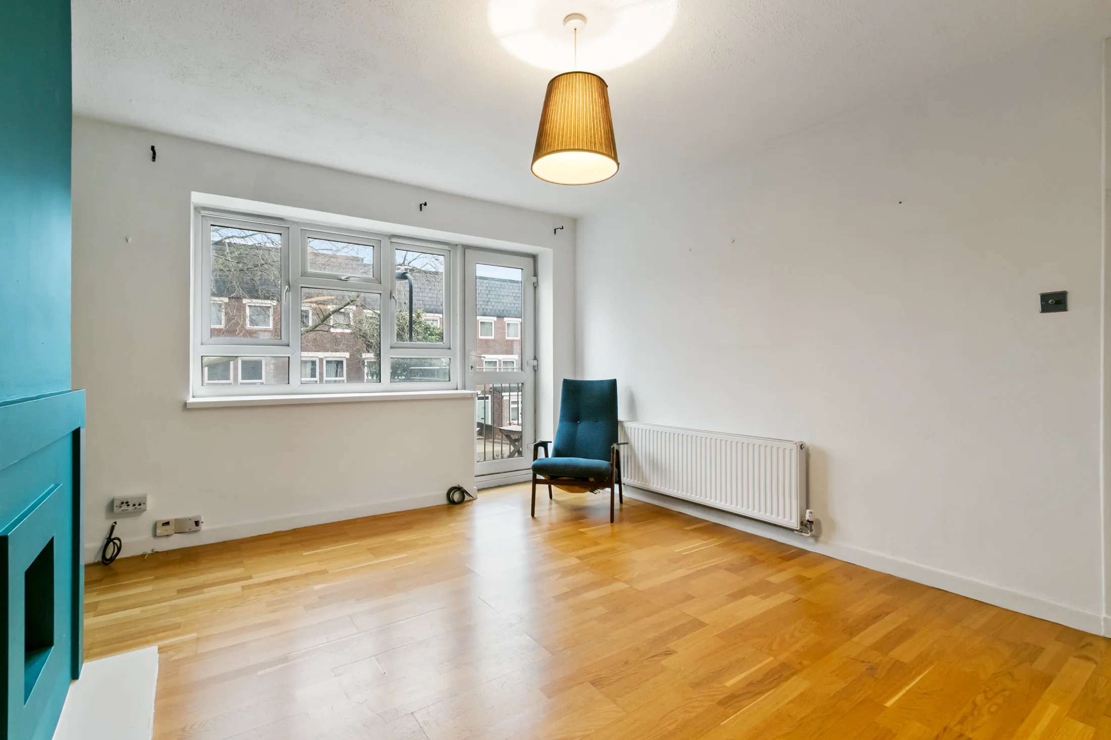 Living room with timber flooring and large windows