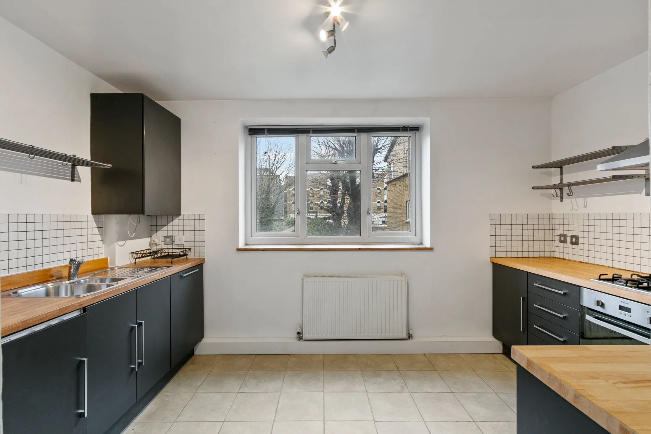 Fitted kitchen with dark cabinetry