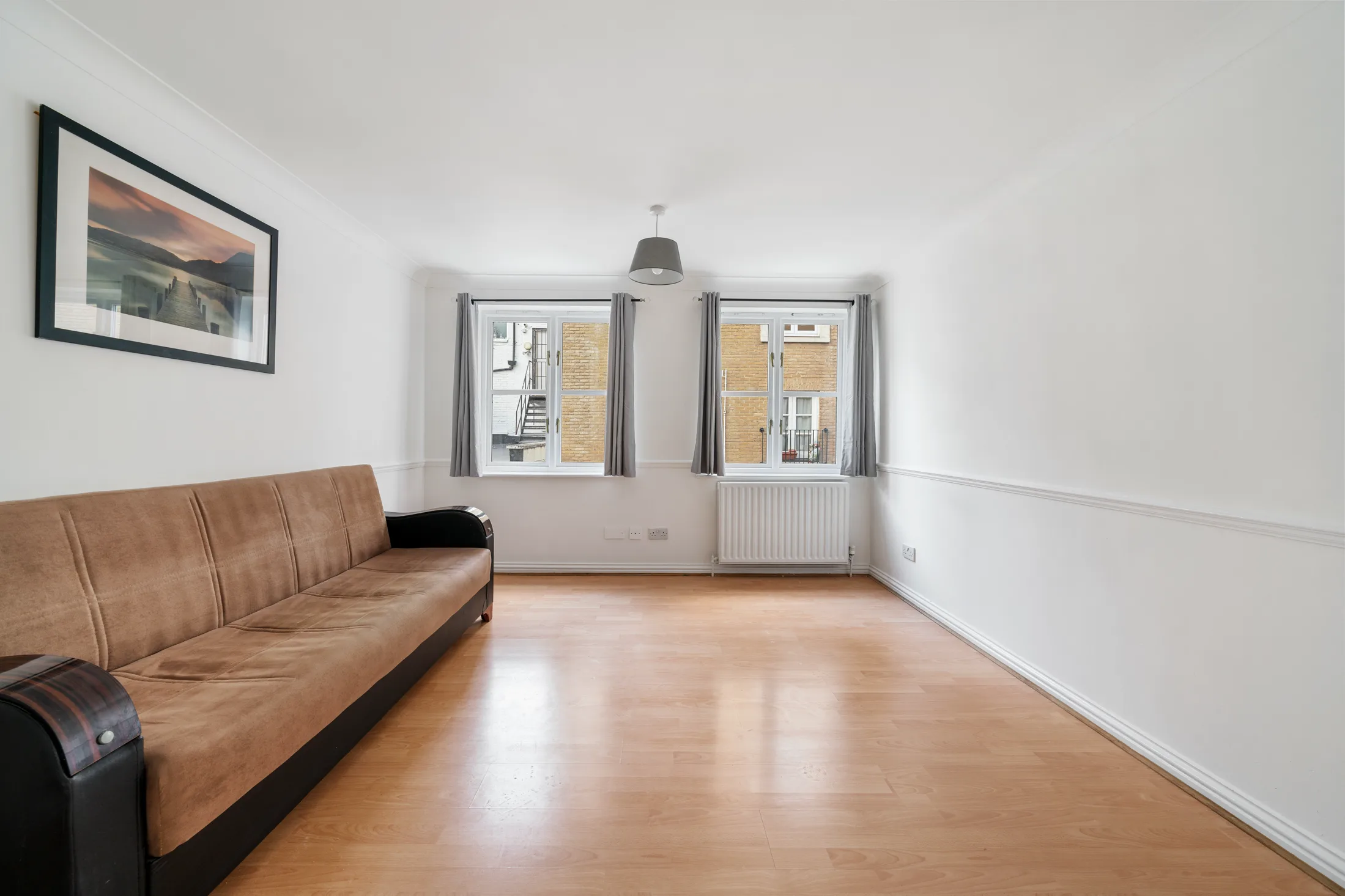 Reception room with a sofa, artwork and windows