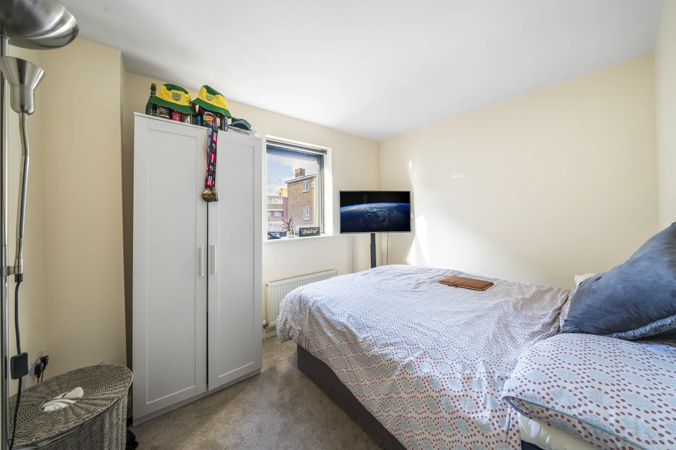 Bedroom with a double bed, wardrobe and natural light