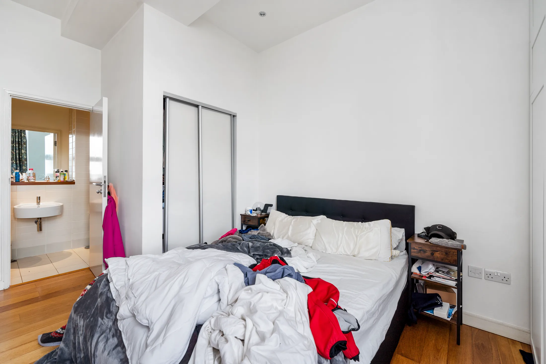 Bedroom with a double bed and timber flooring