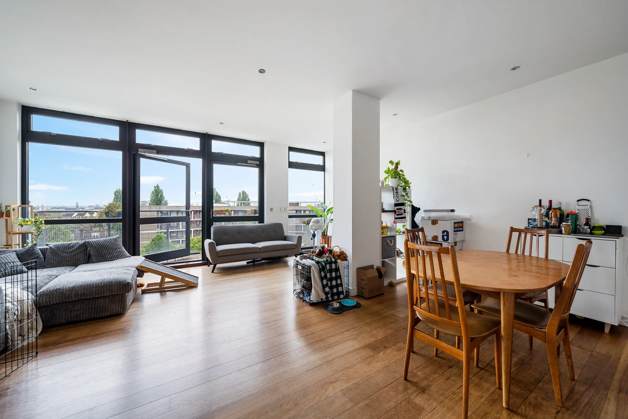 Open-plan reception and dining space with full-height windows