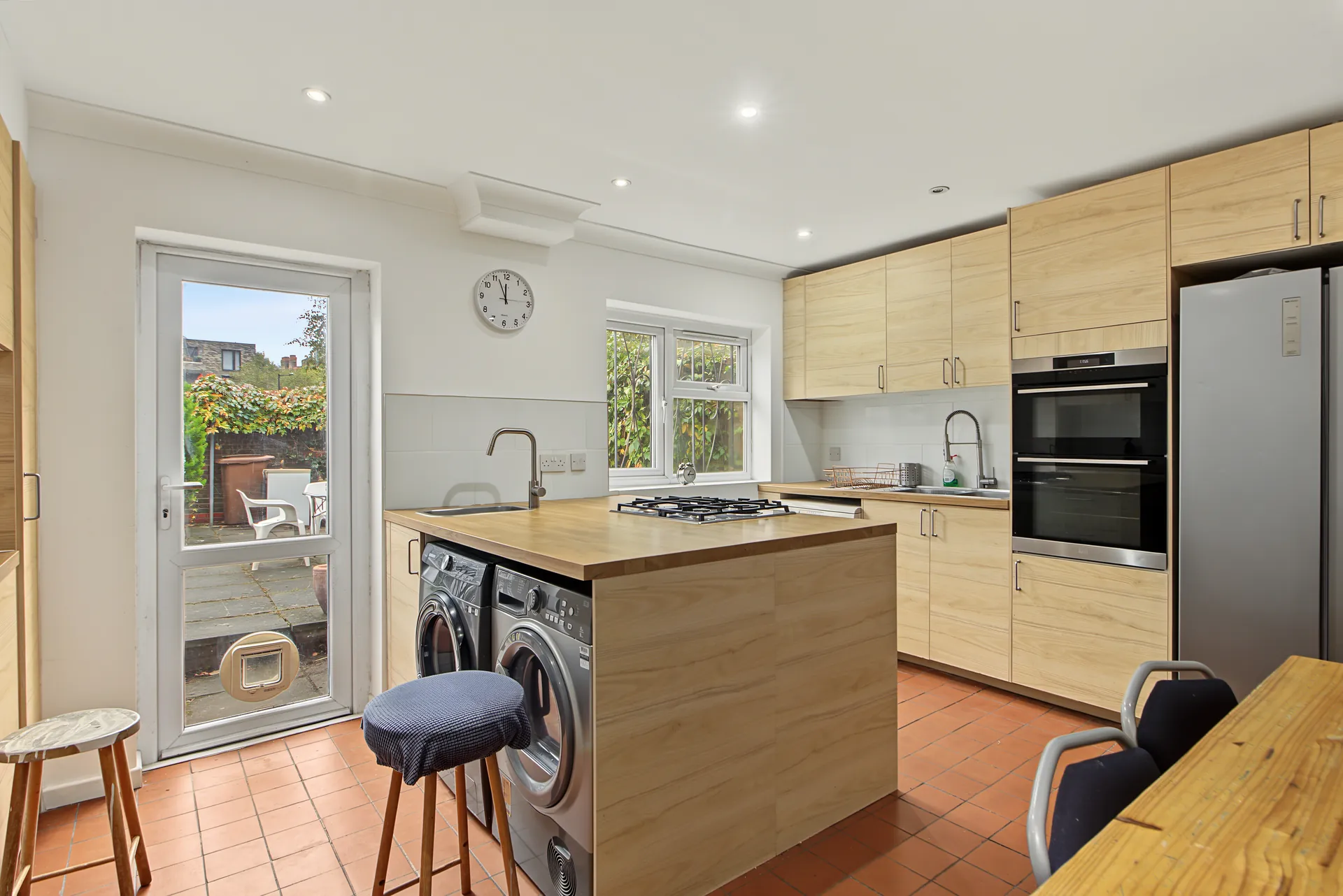 Kitchen with integrated oven, gas hob and a door out to the garden