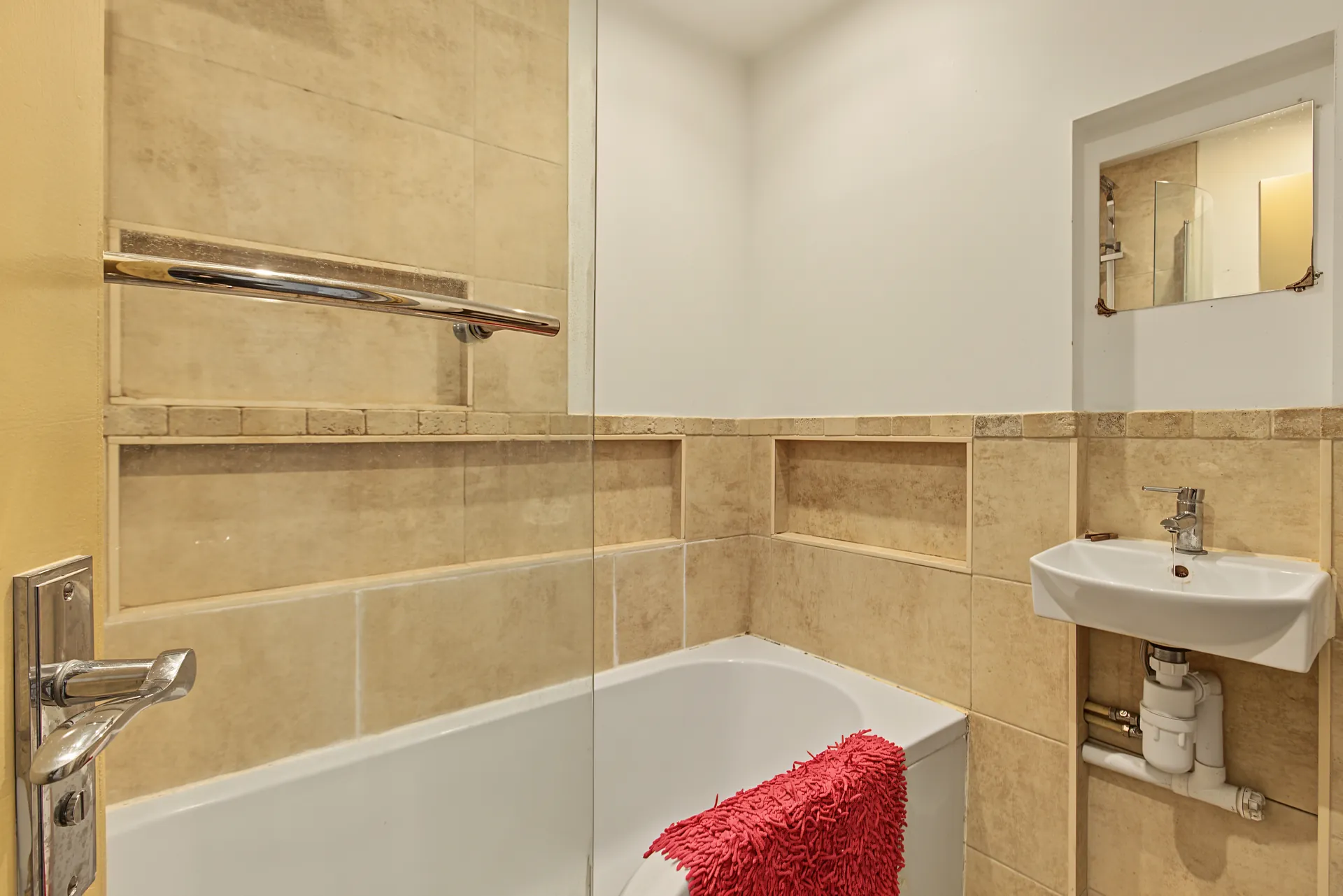 Family bathroom with a bath, basin and tiled walls