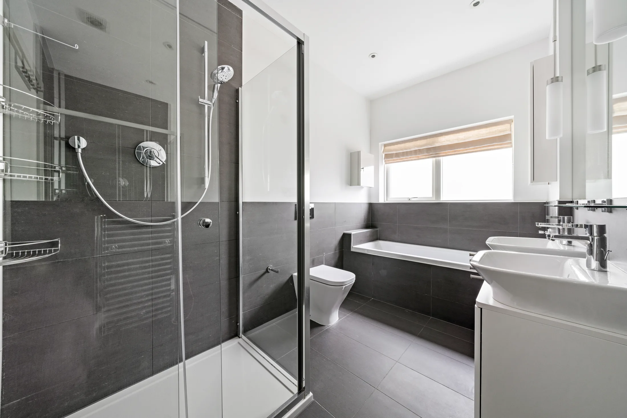 Shower room with glass enclosure and white sanitaryware
