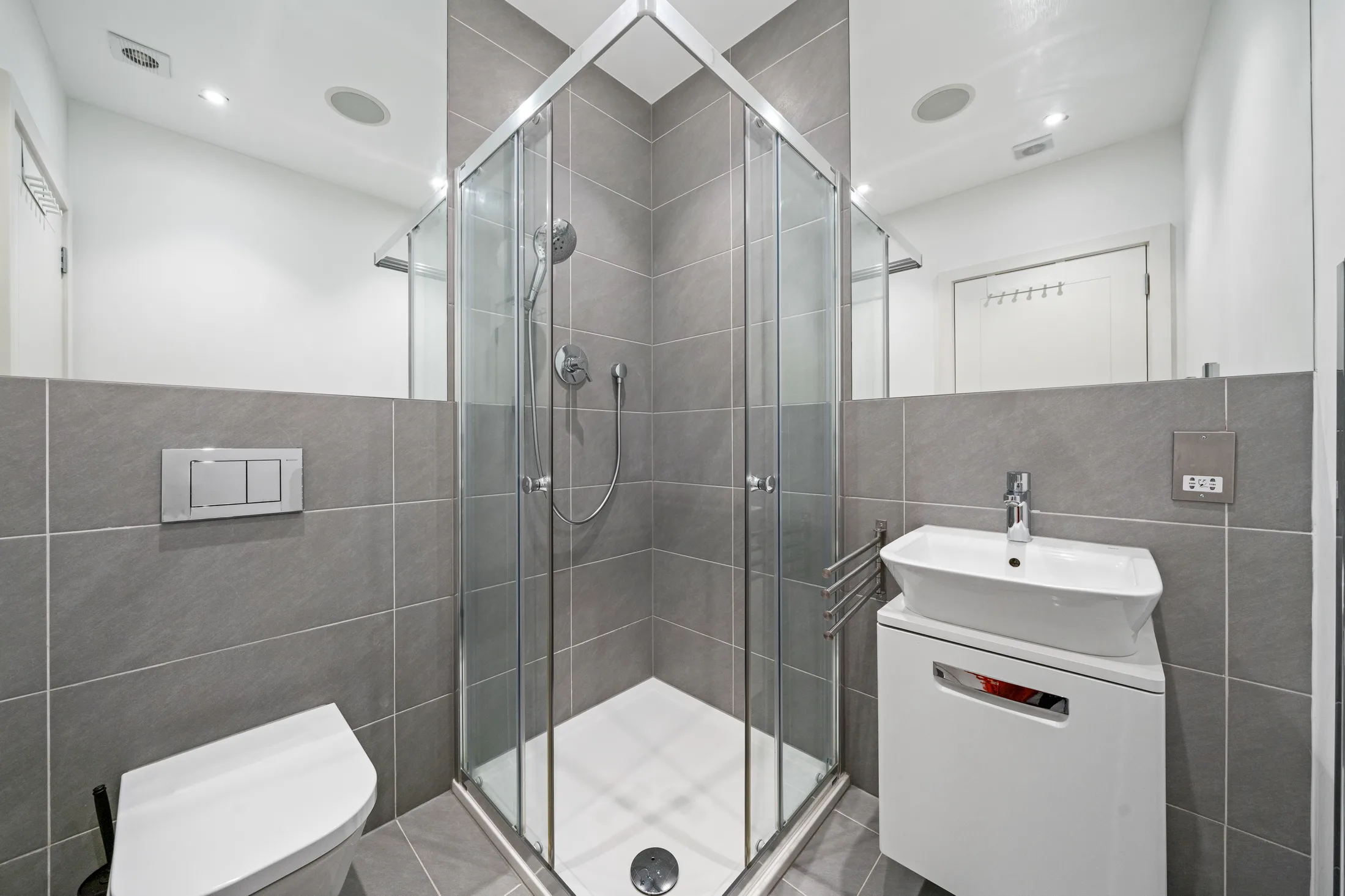 Shower room with glass enclosure and white sanitaryware