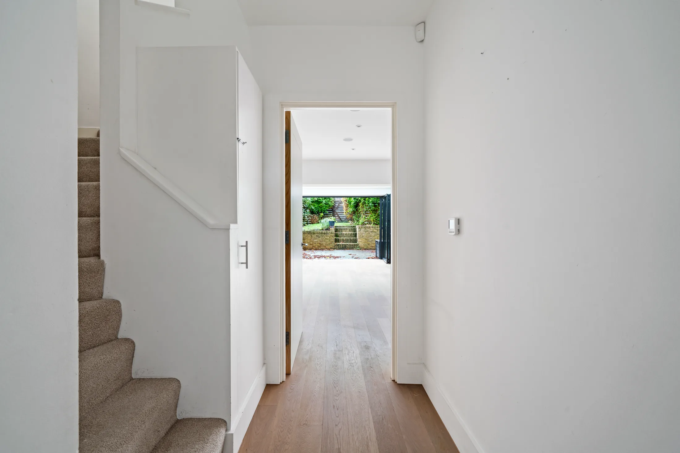 Hallway with staircase and timber flooring