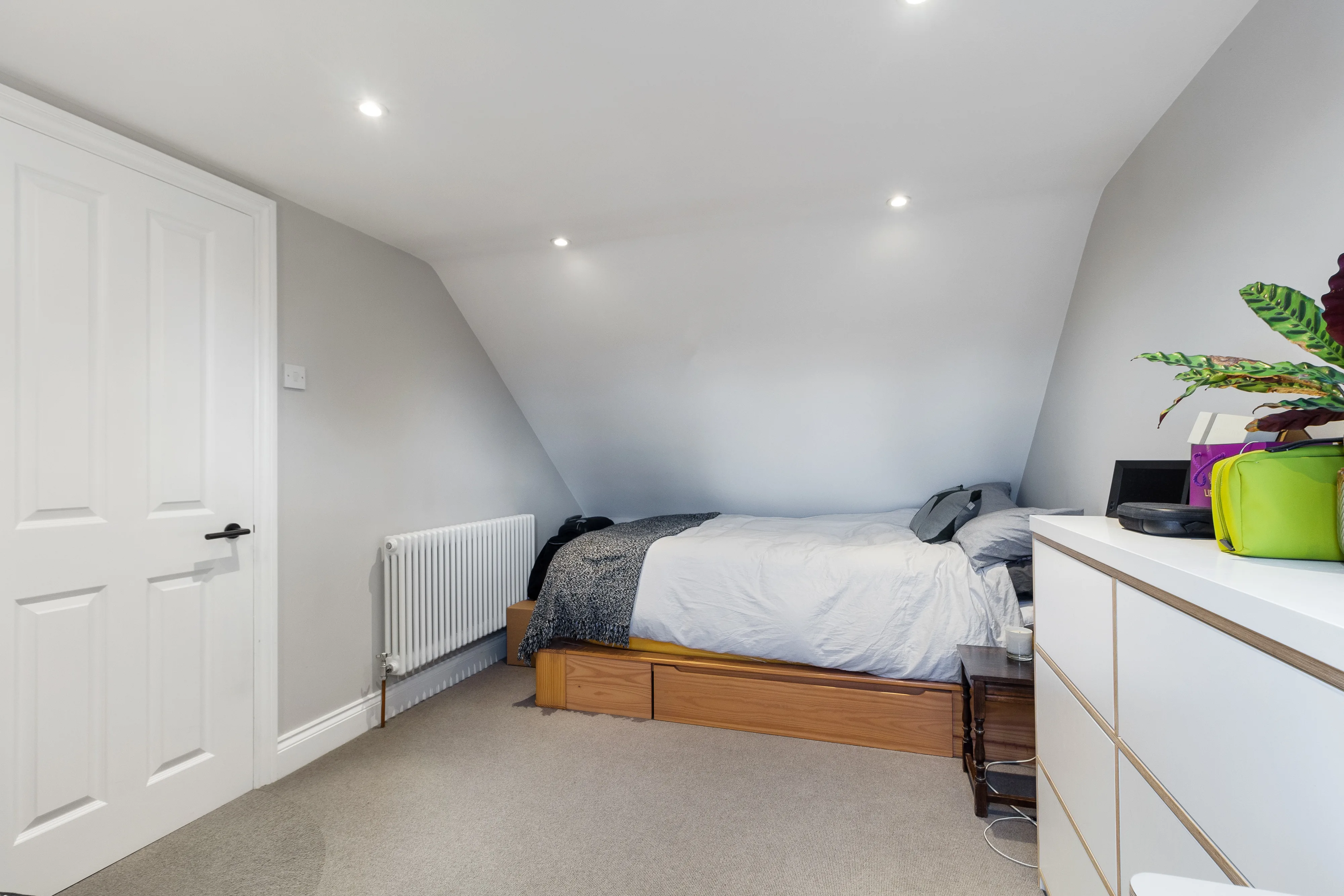 Bedroom with a bed and sloping ceiling
